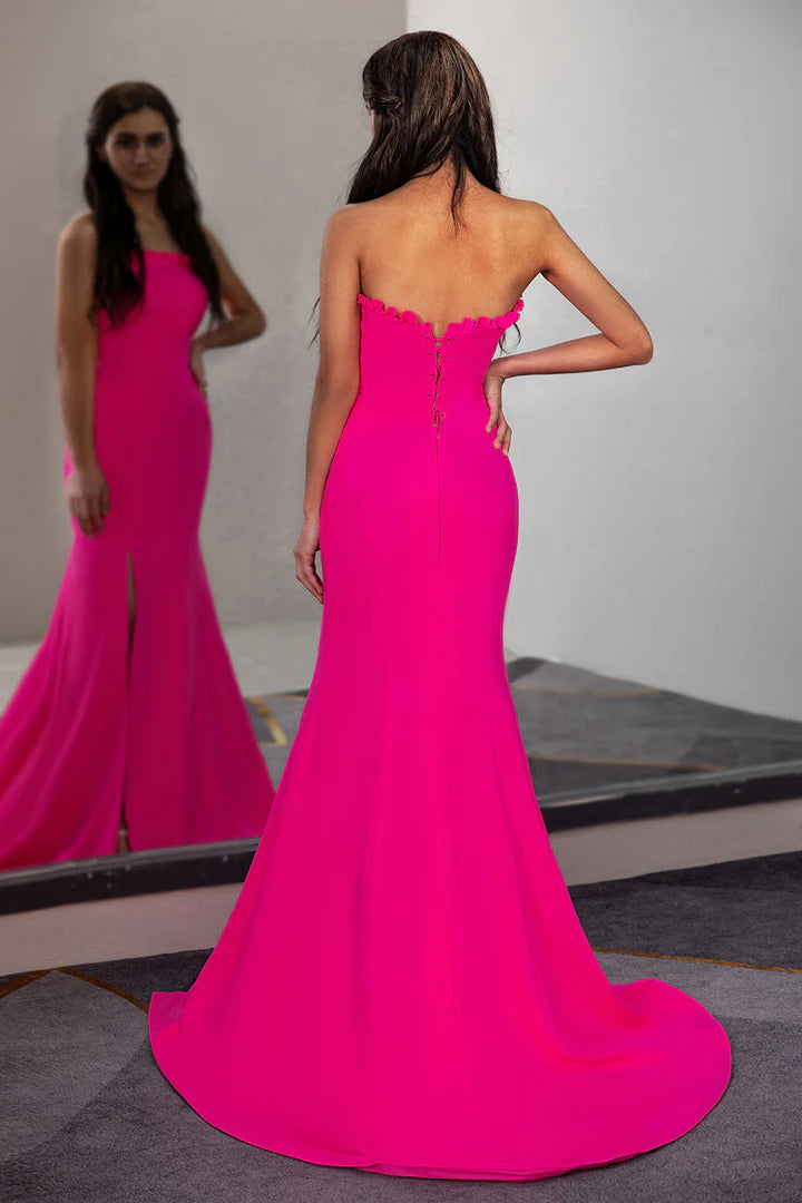 A fitted pleated waist cinched strapless side slit ball dress