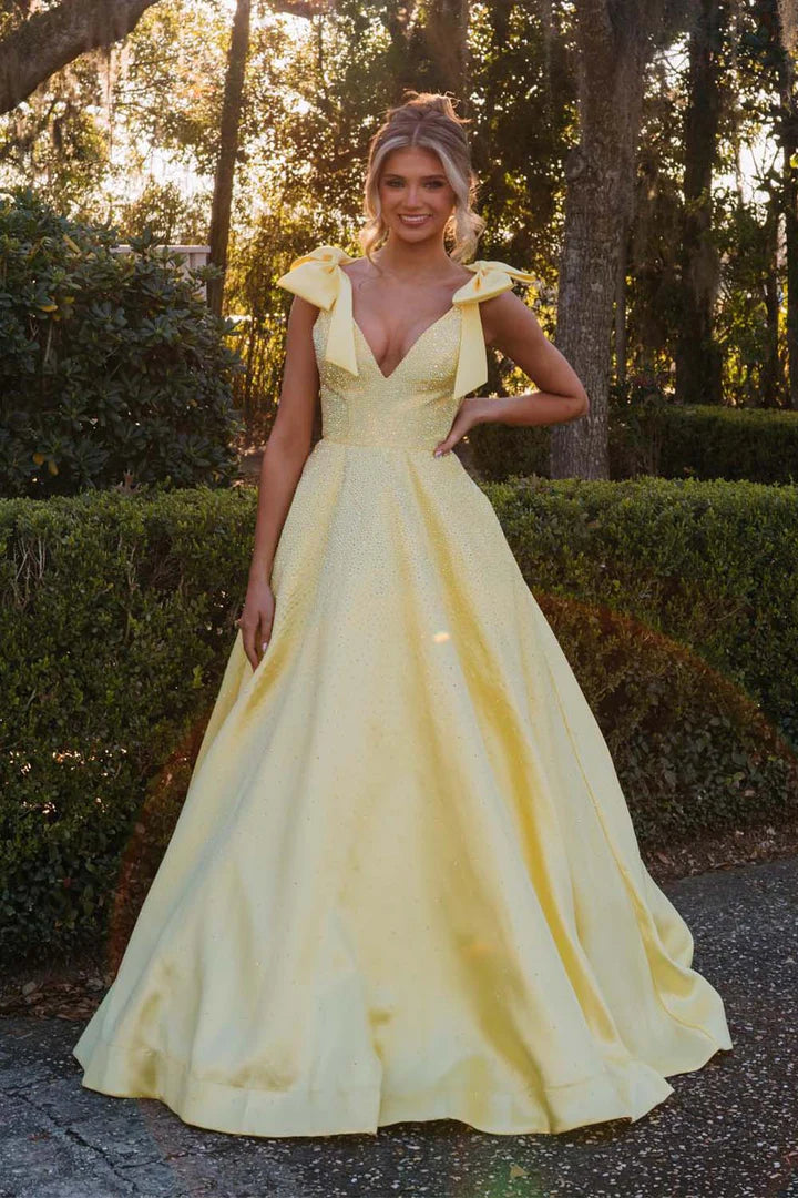 A-line beaded ball gown with suspender bow and deep V-floor skirt