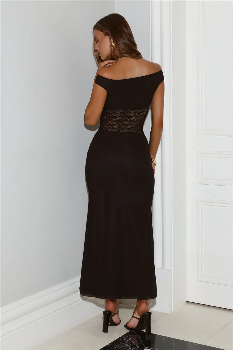 An elegant black off-the-shoulder midi dress with a lace mesh cutout design at the waist, pleated details at the hem, and short sleeves.