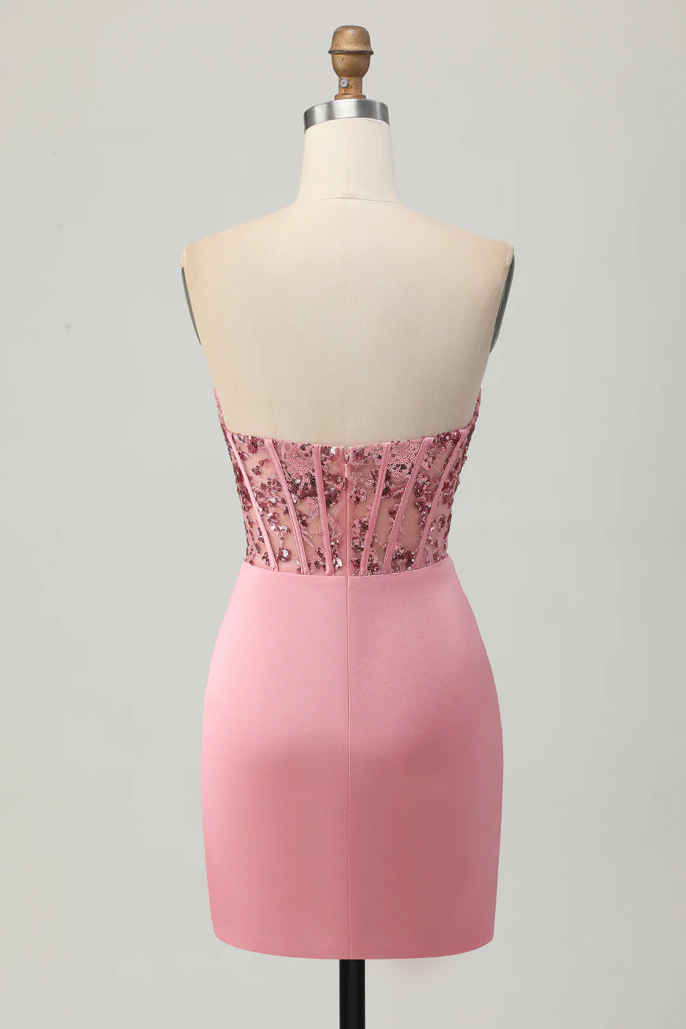 Close-up of the blush sequin fabric and corset detail.