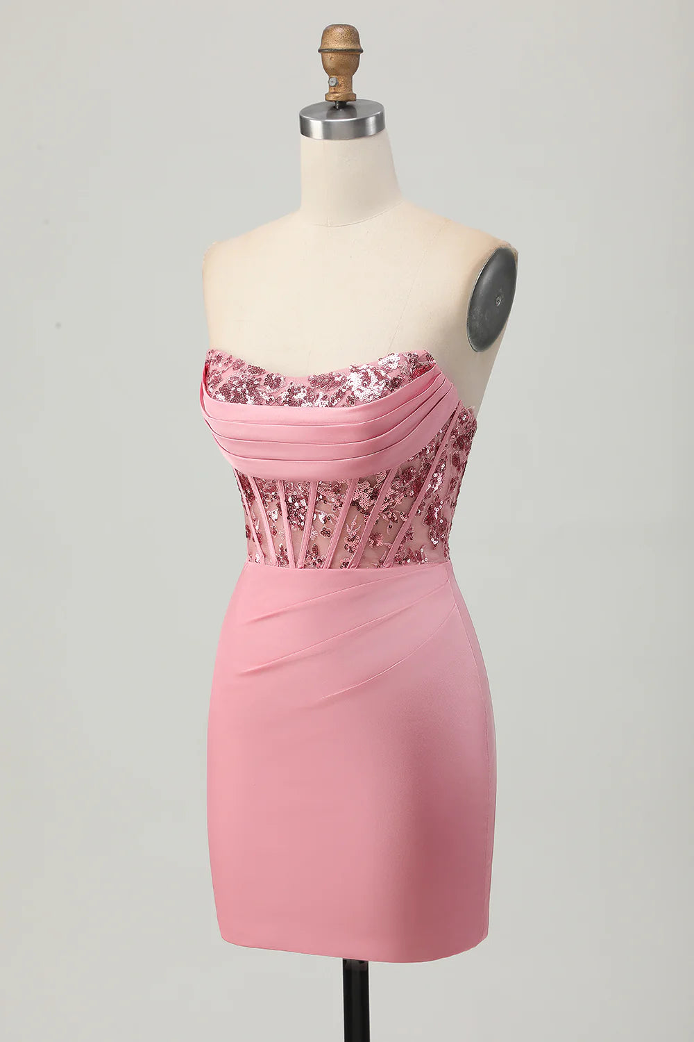 Model wearing a fitted blush sequined formal gown.