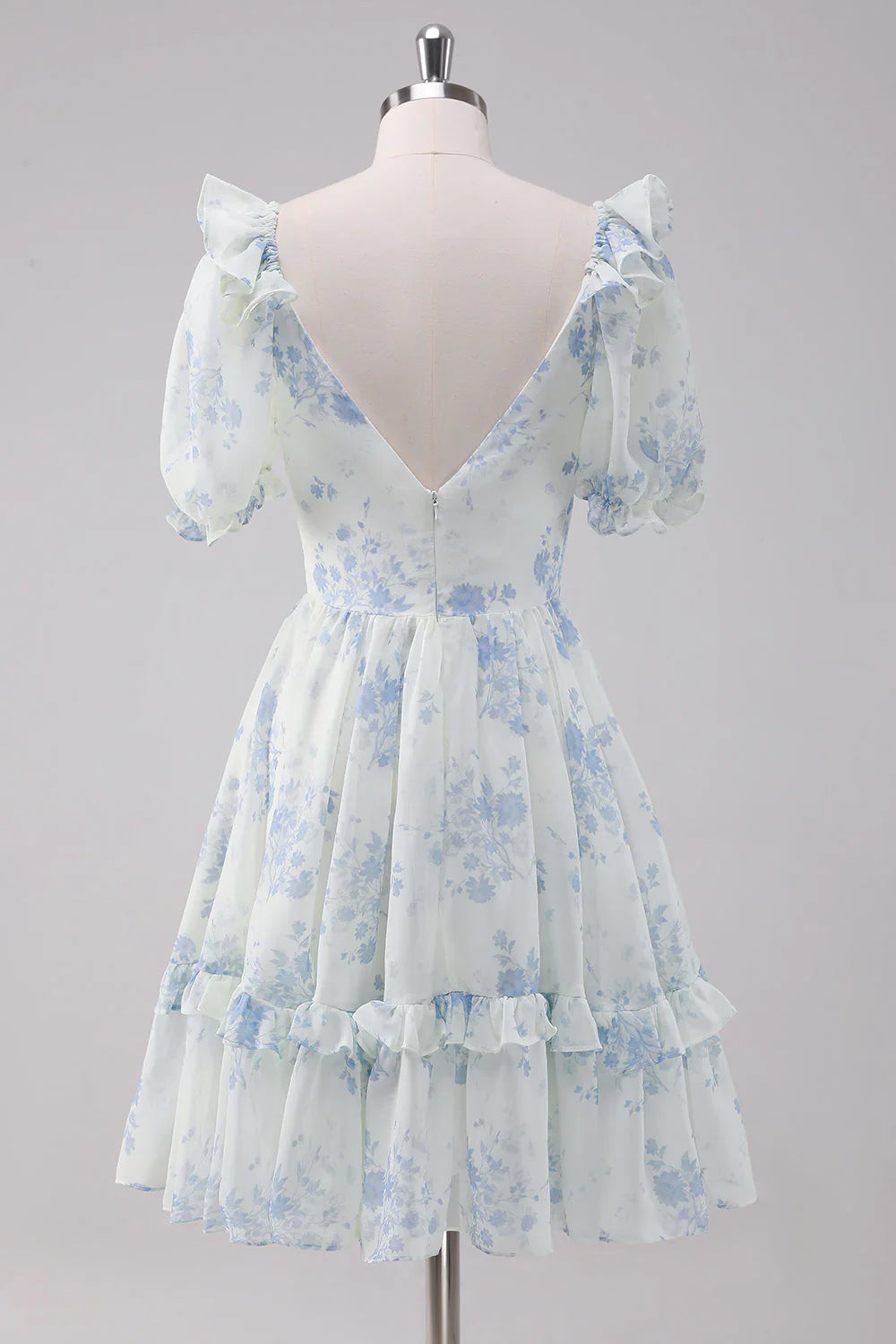 Side view of a light blue floral short dress with spaghetti straps.