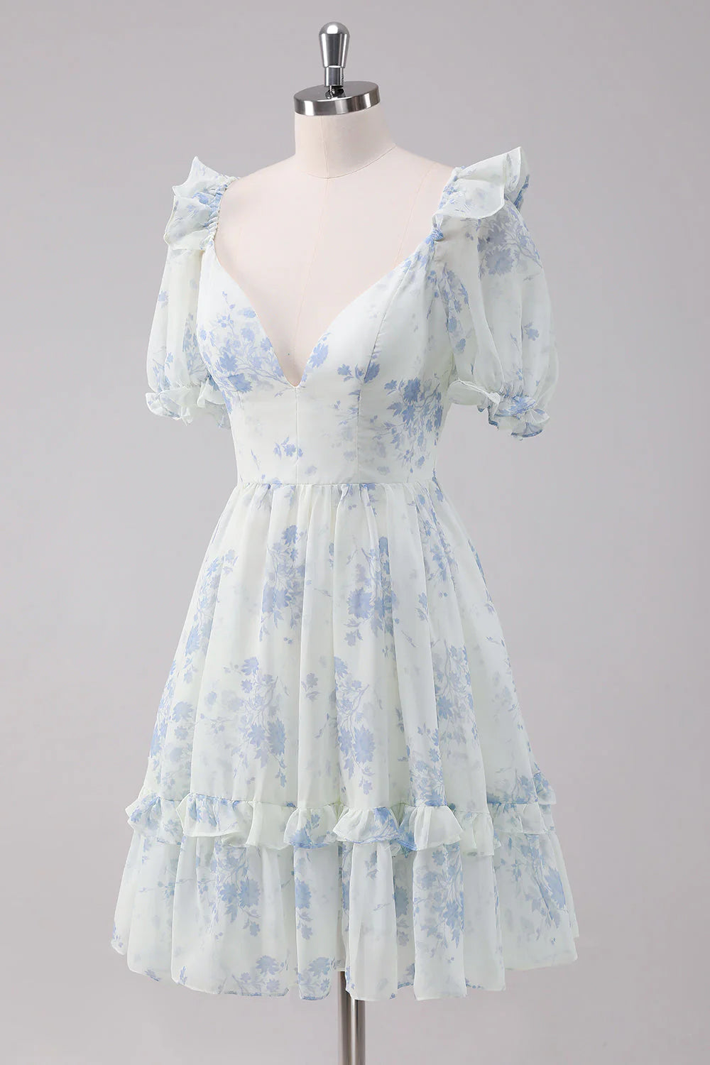 Back view of a light blue floral short dress with spaghetti straps.