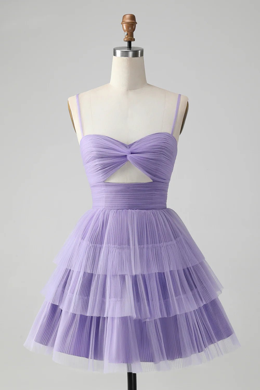 Model wearing a purple A-line spaghetti strap short homecoming dress with tiered skirt and hollow-out detail.