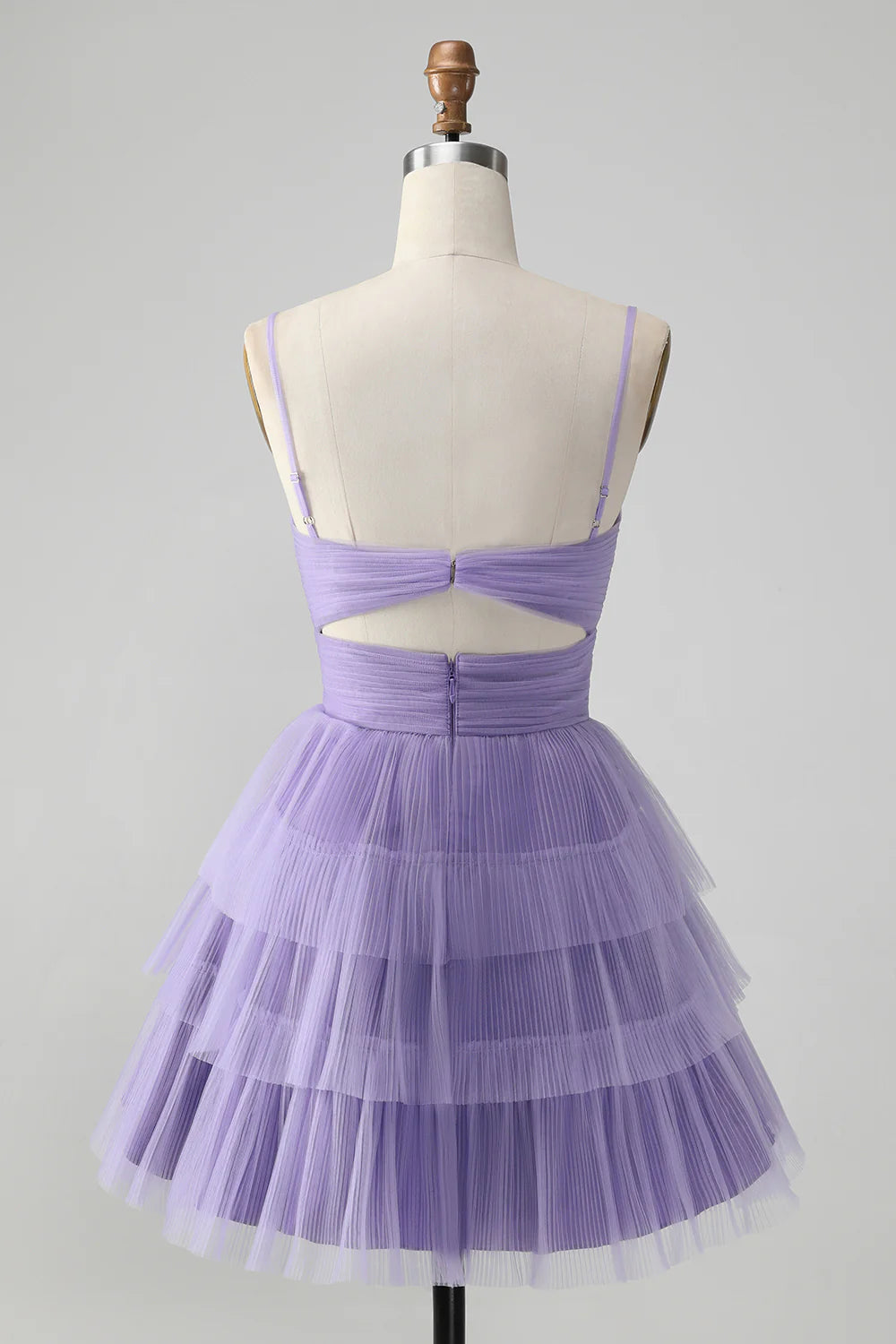 Back view of a purple A-line homecoming dress showing spaghetti straps and tiered skirt.