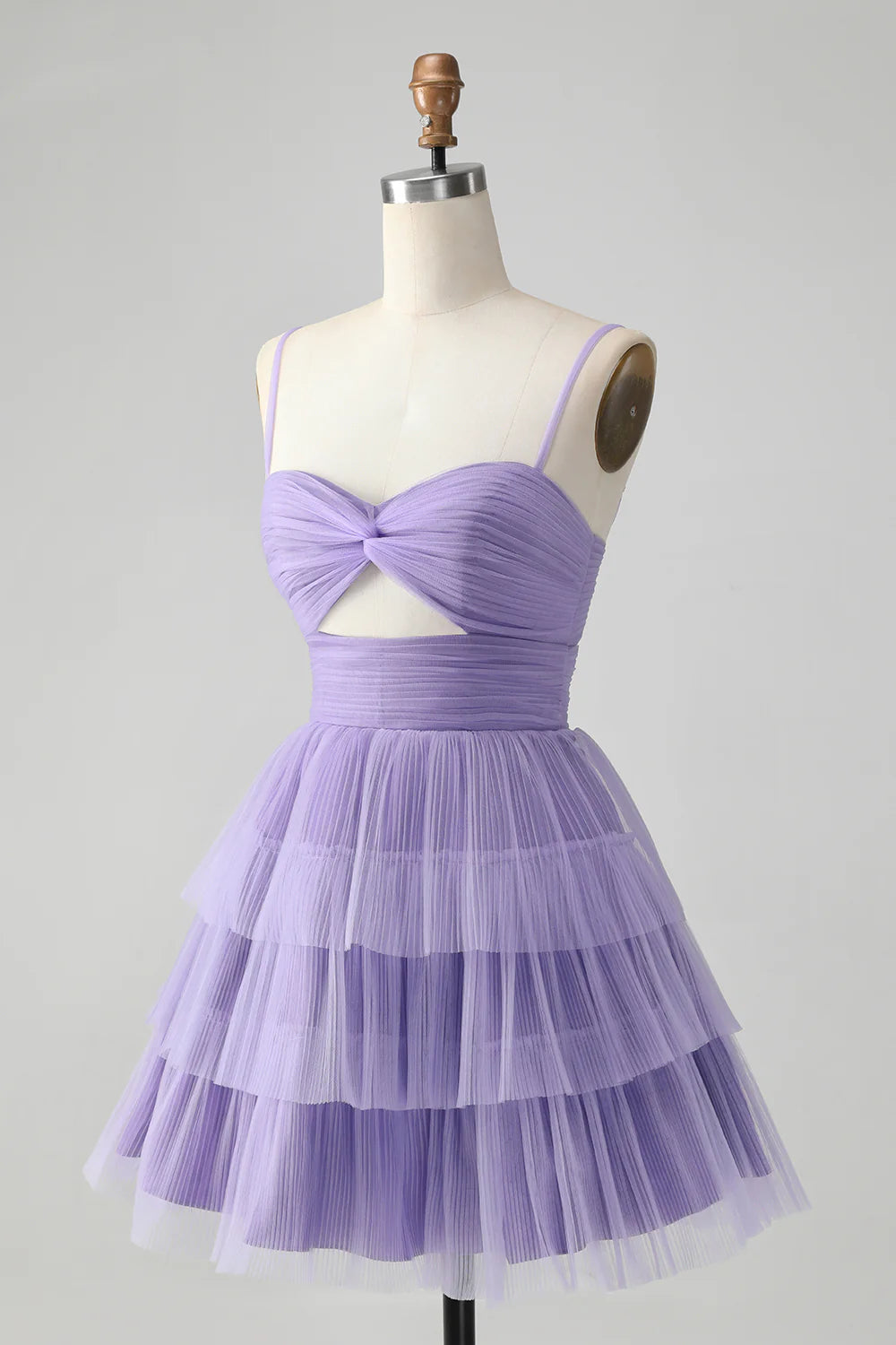 Close-up of the tiered skirt and hollow-out detail on a purple homecoming dress.
