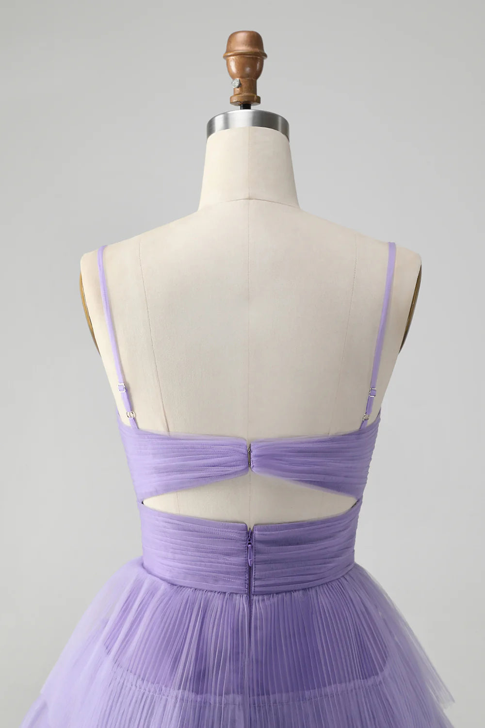 Full length view of a purple tiered homecoming dress with spaghetti straps.