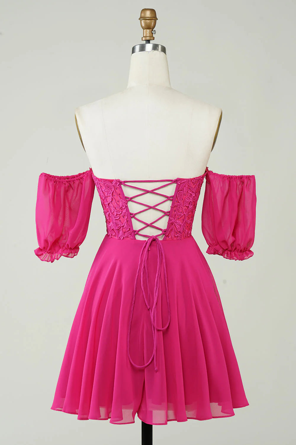 Back view of the fuchsia A-line short homecoming dress, showing corset lacing.