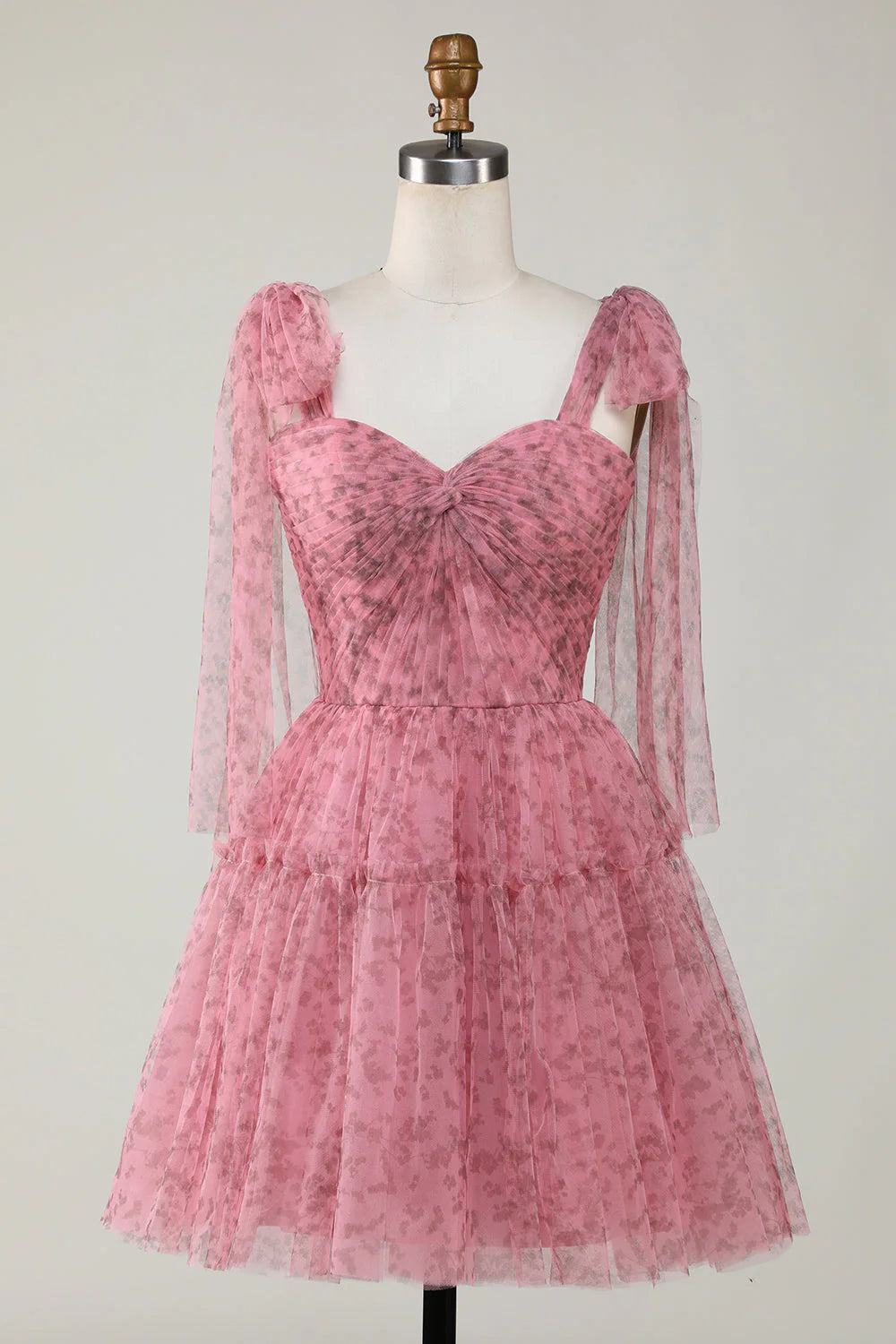 Blush A-line short homecoming dress with sweetheart strapless neckline and printed tulle fabric.