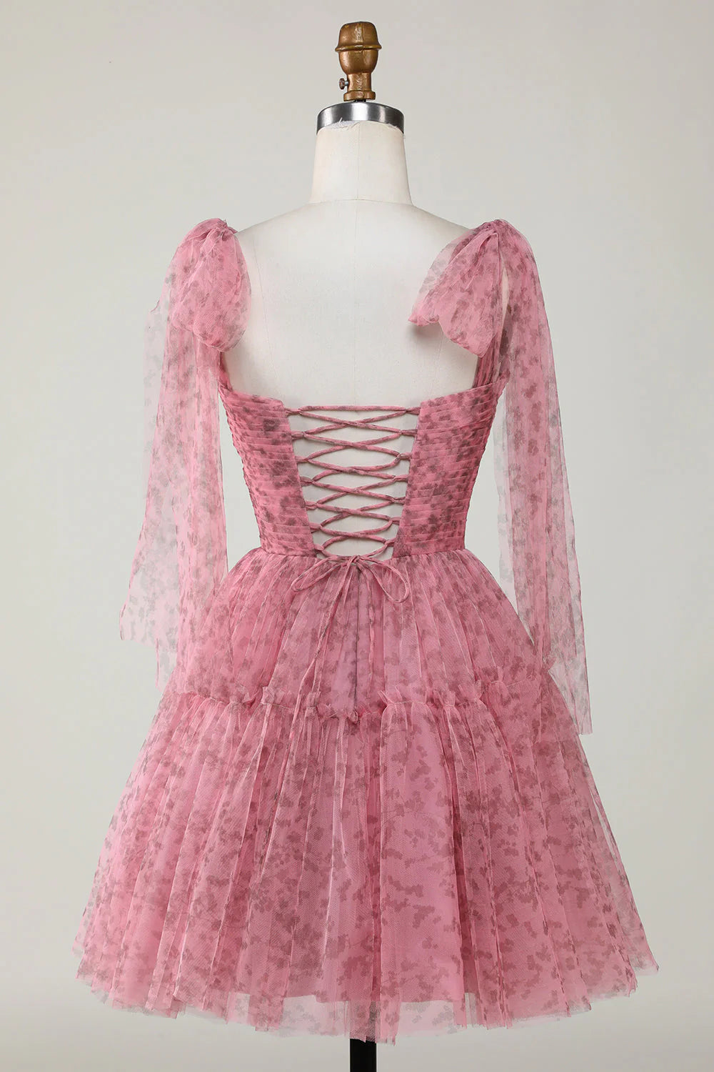 Back view of a blush A-line short tulle dress, showcasing the elegant silhouette.