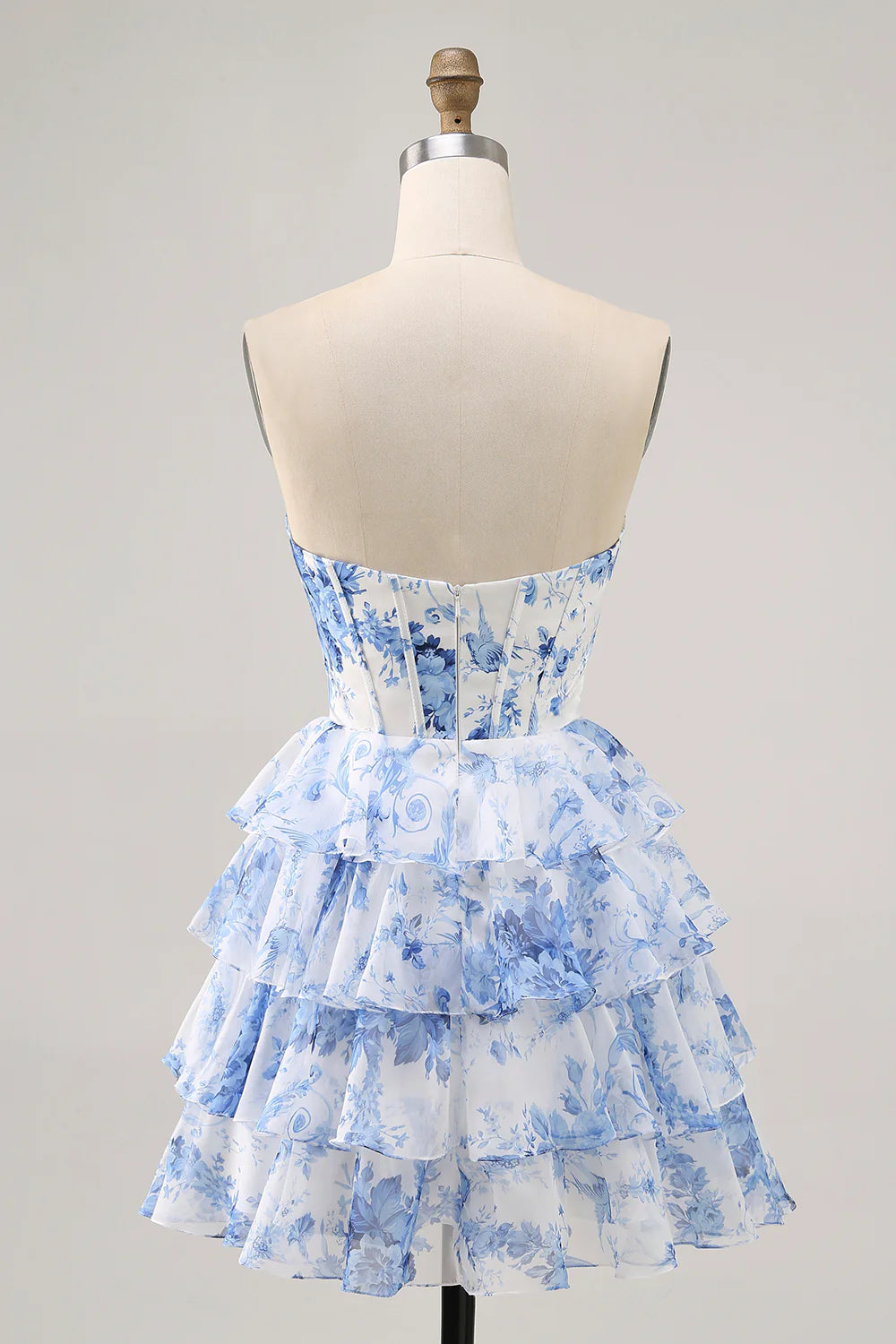 Back view of the white and blue floral A-line strapless tiered short homecoming dress.