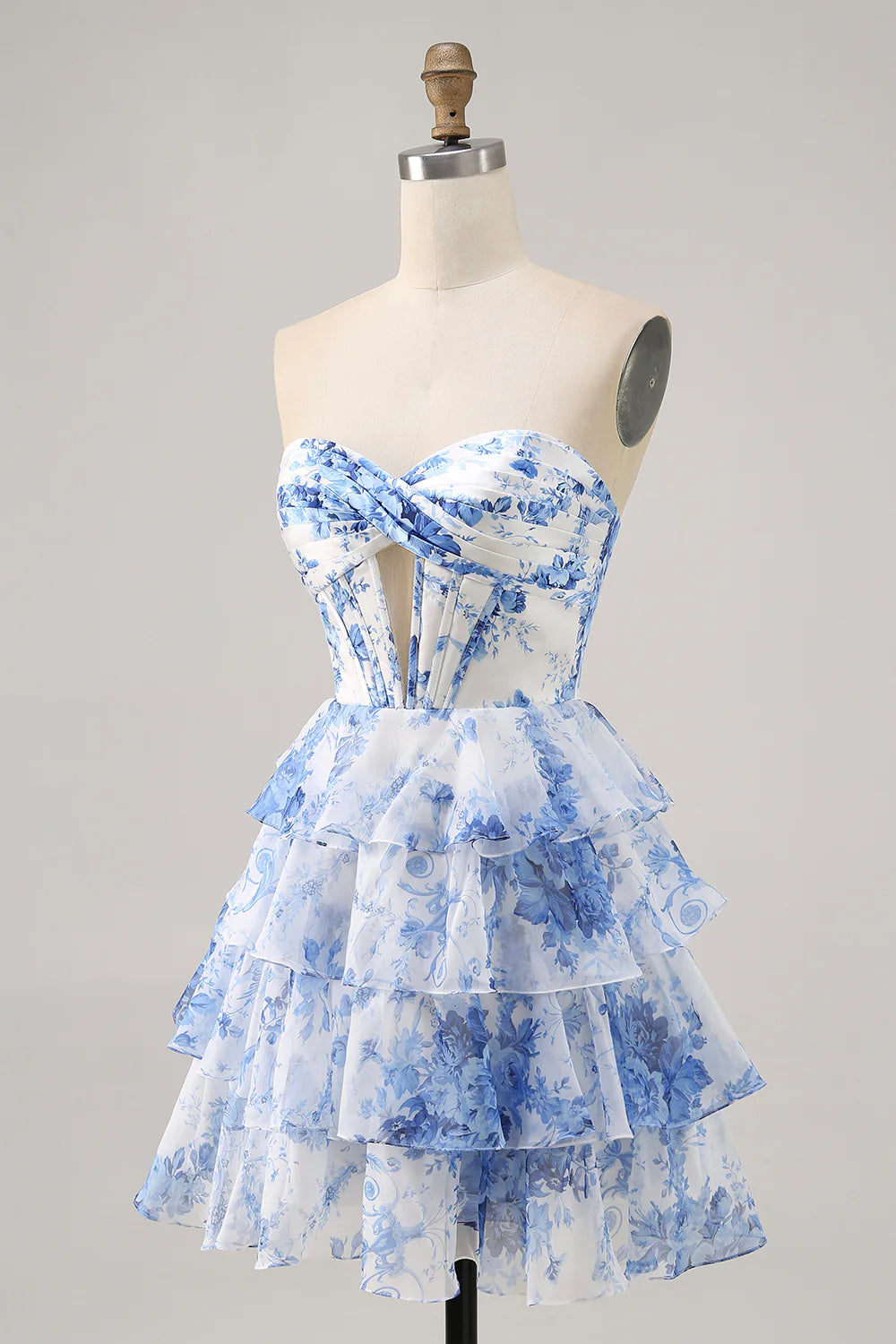 Side view of the white and blue floral A-line strapless tiered short homecoming dress.