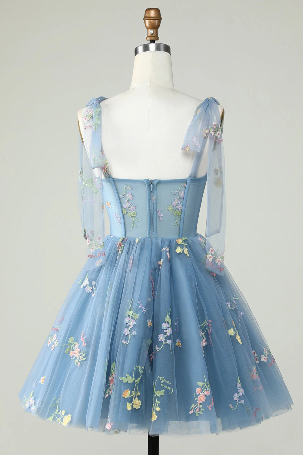 Back view of a grey blue A-line short homecoming dress with spaghetti straps.