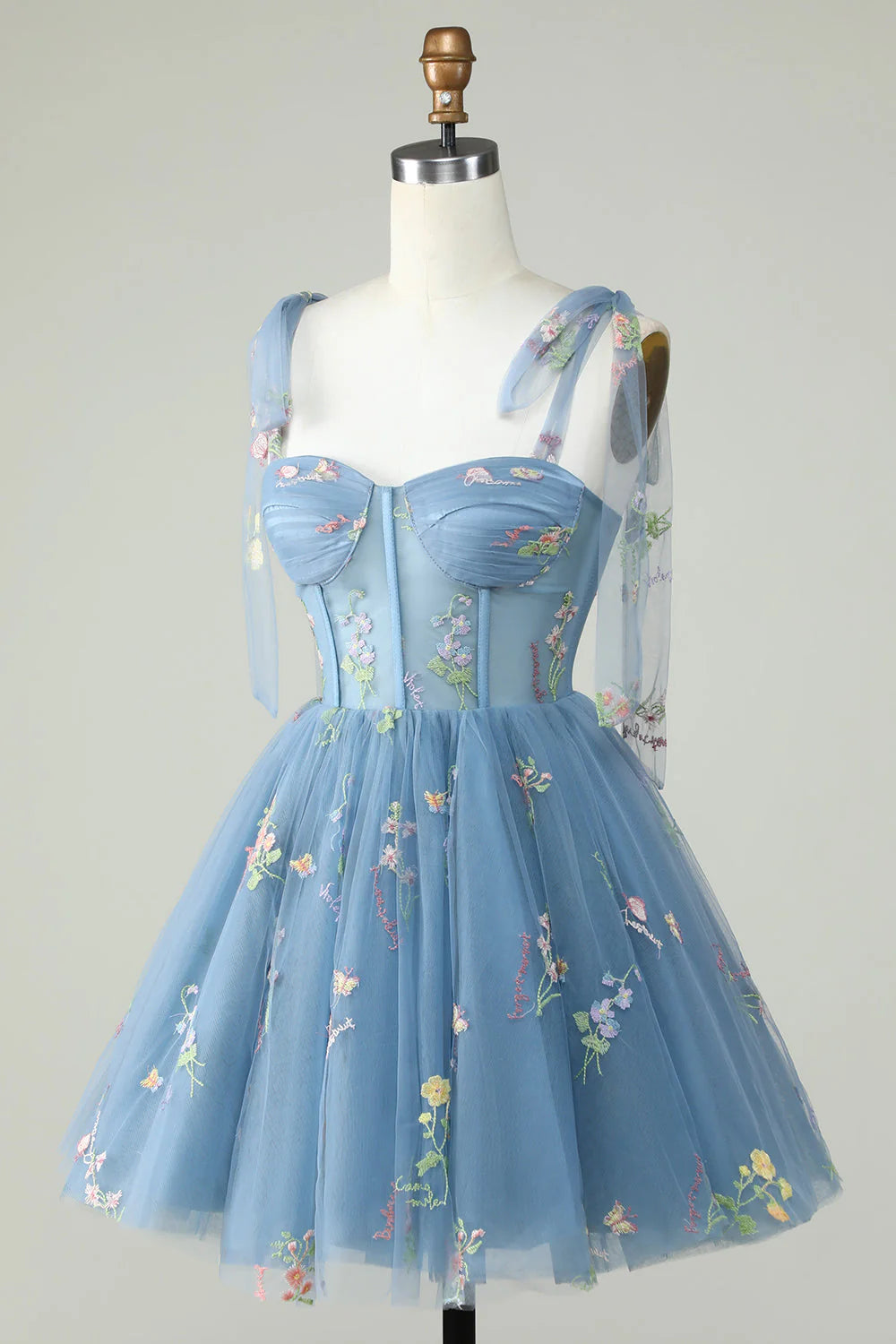 Side view of a grey blue A-line short homecoming dress with delicate appliques.