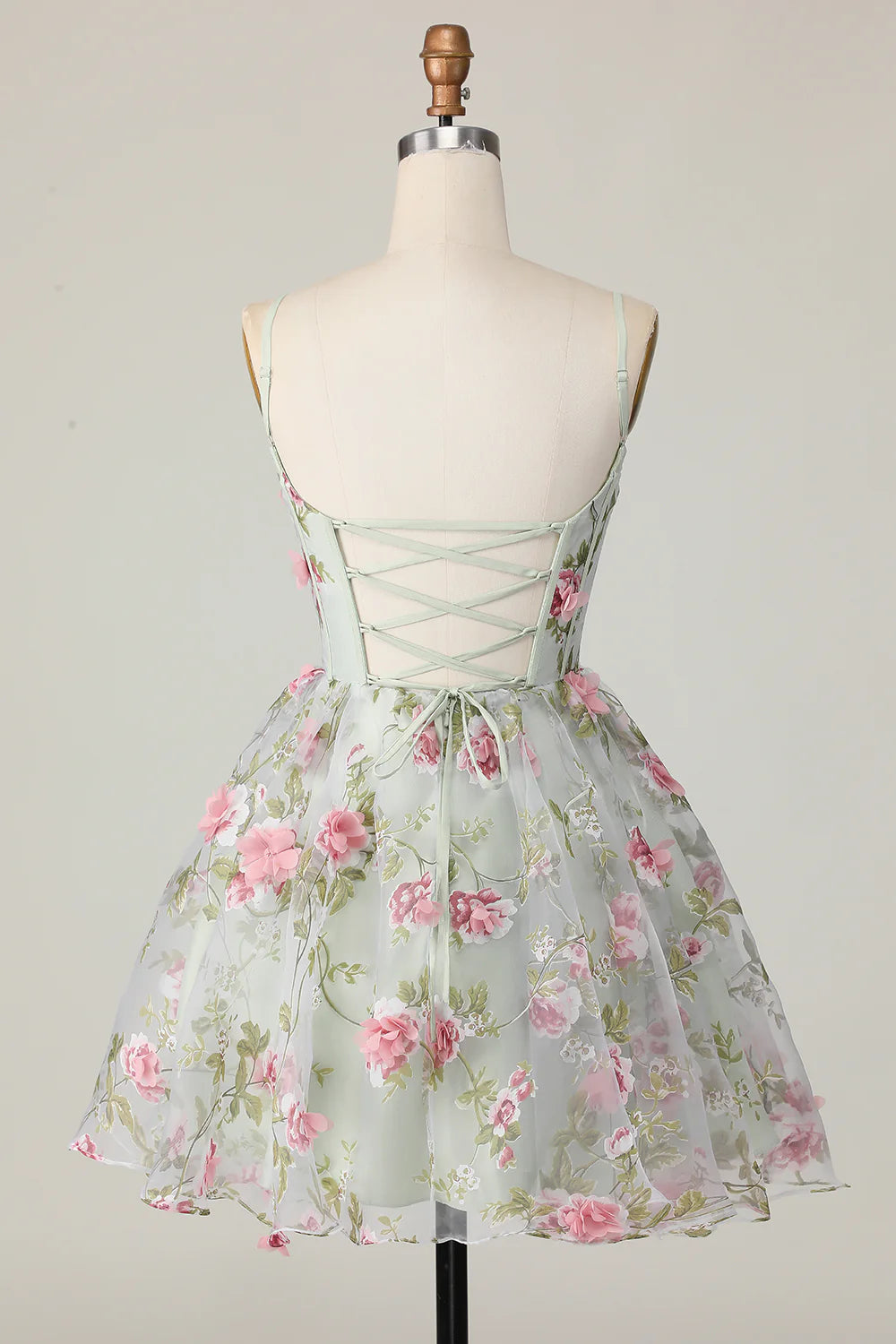 Back view of sage floral homecoming dress showing lace-up detail.