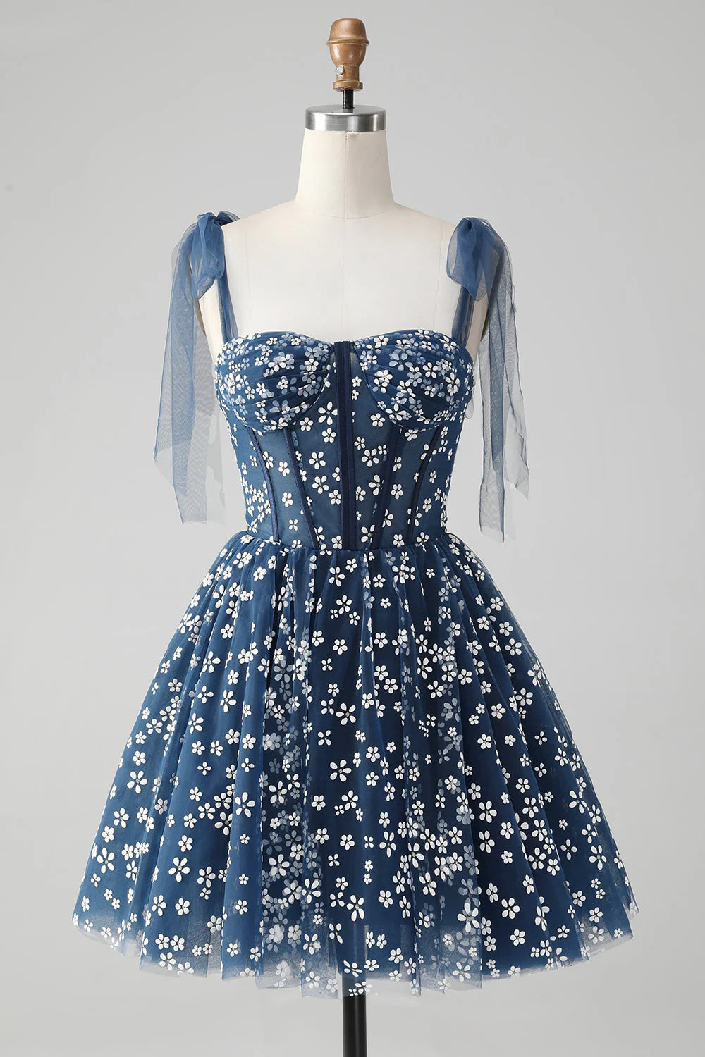 Navy A-line short homecoming dress featuring spaghetti straps and a printed corset.