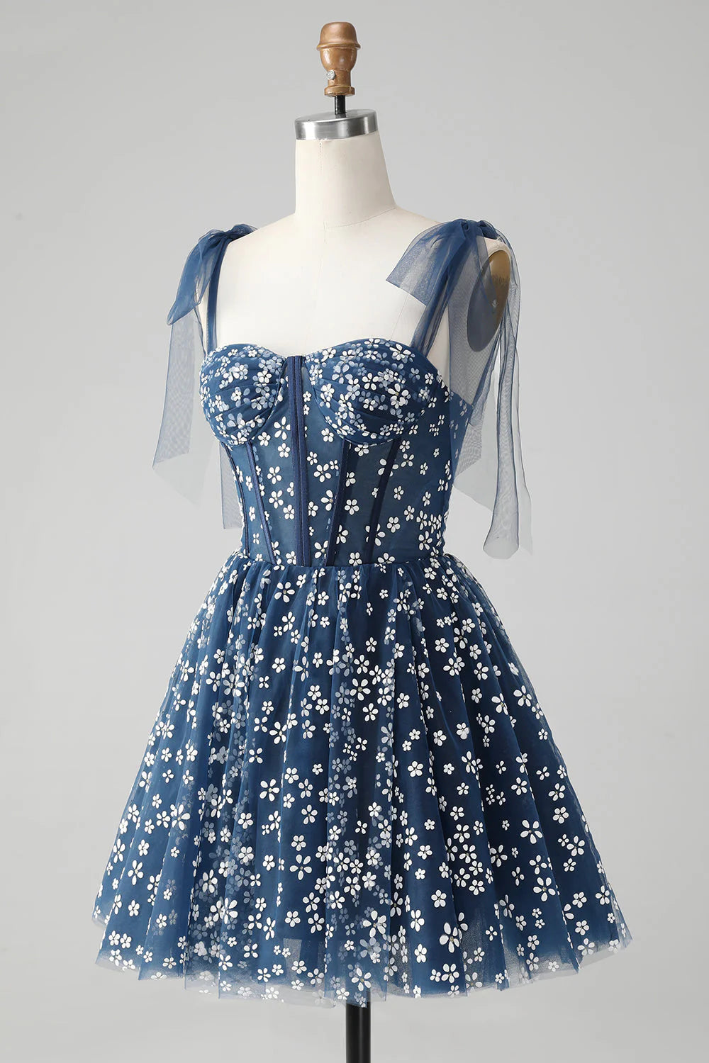 Full view of the navy A-line short homecoming dress with spaghetti straps.