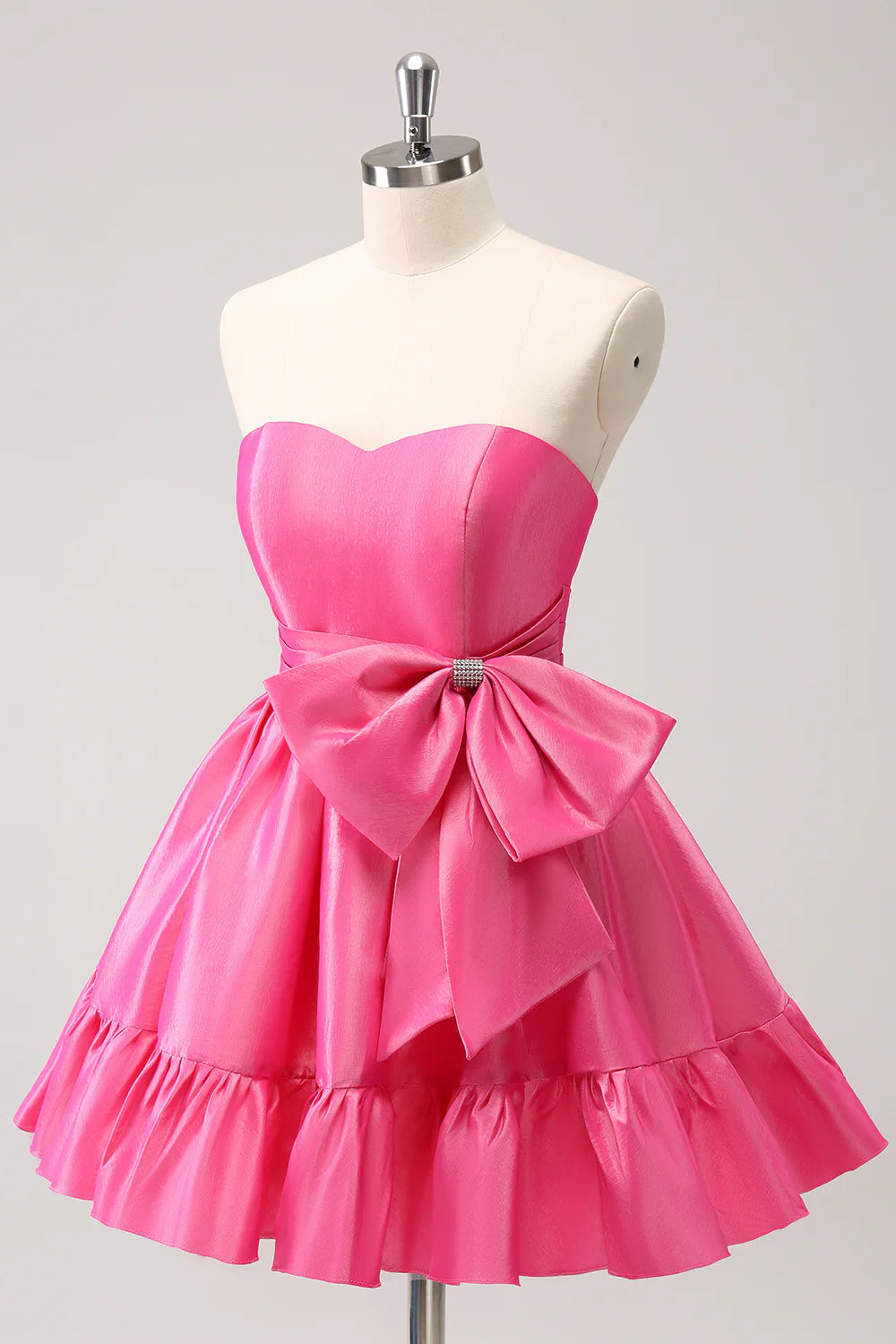 Back view of a hot pink A-line strapless short homecoming dress, showing pleats and bow.
