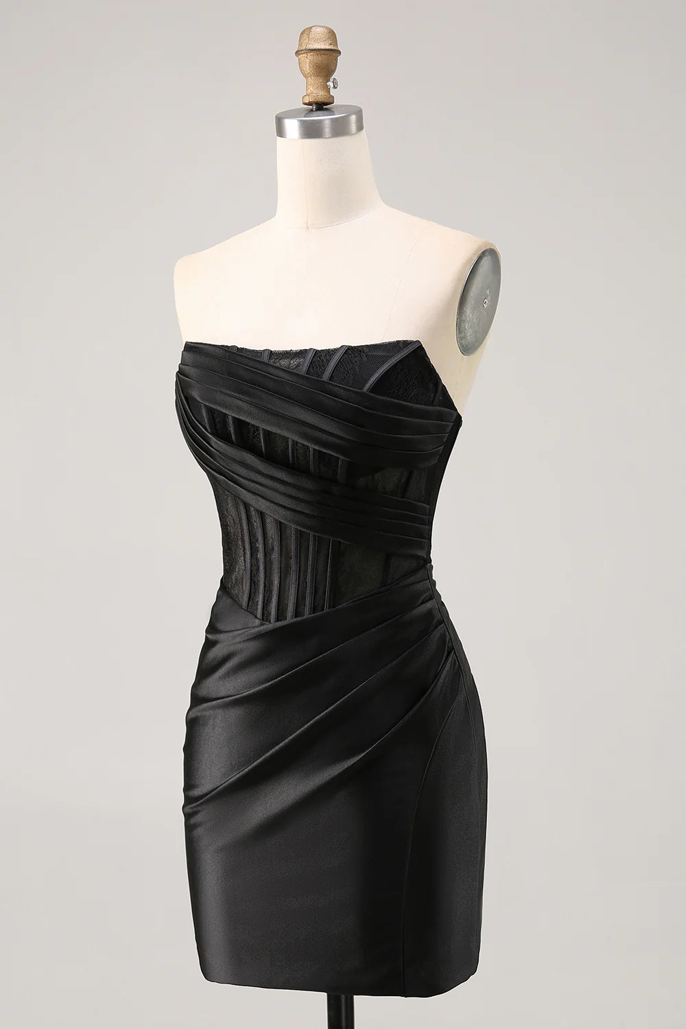 Close-up of the black satin fabric and ruched detail on a bodycon dress.