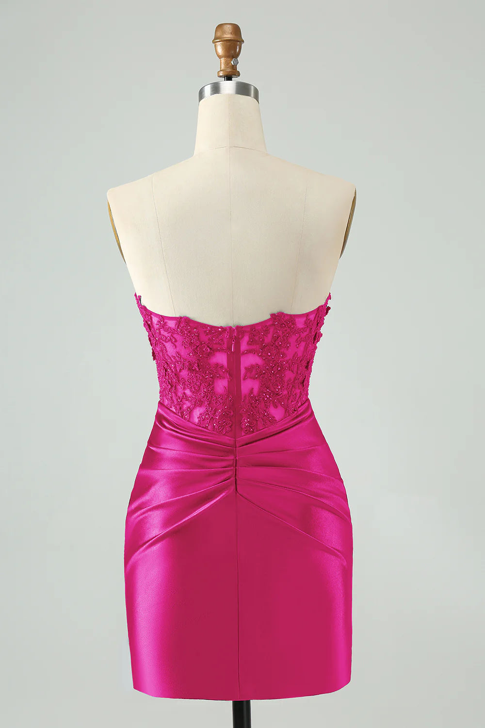Model wearing a fuchsia short bodycon dress with hollow-out and beading.
