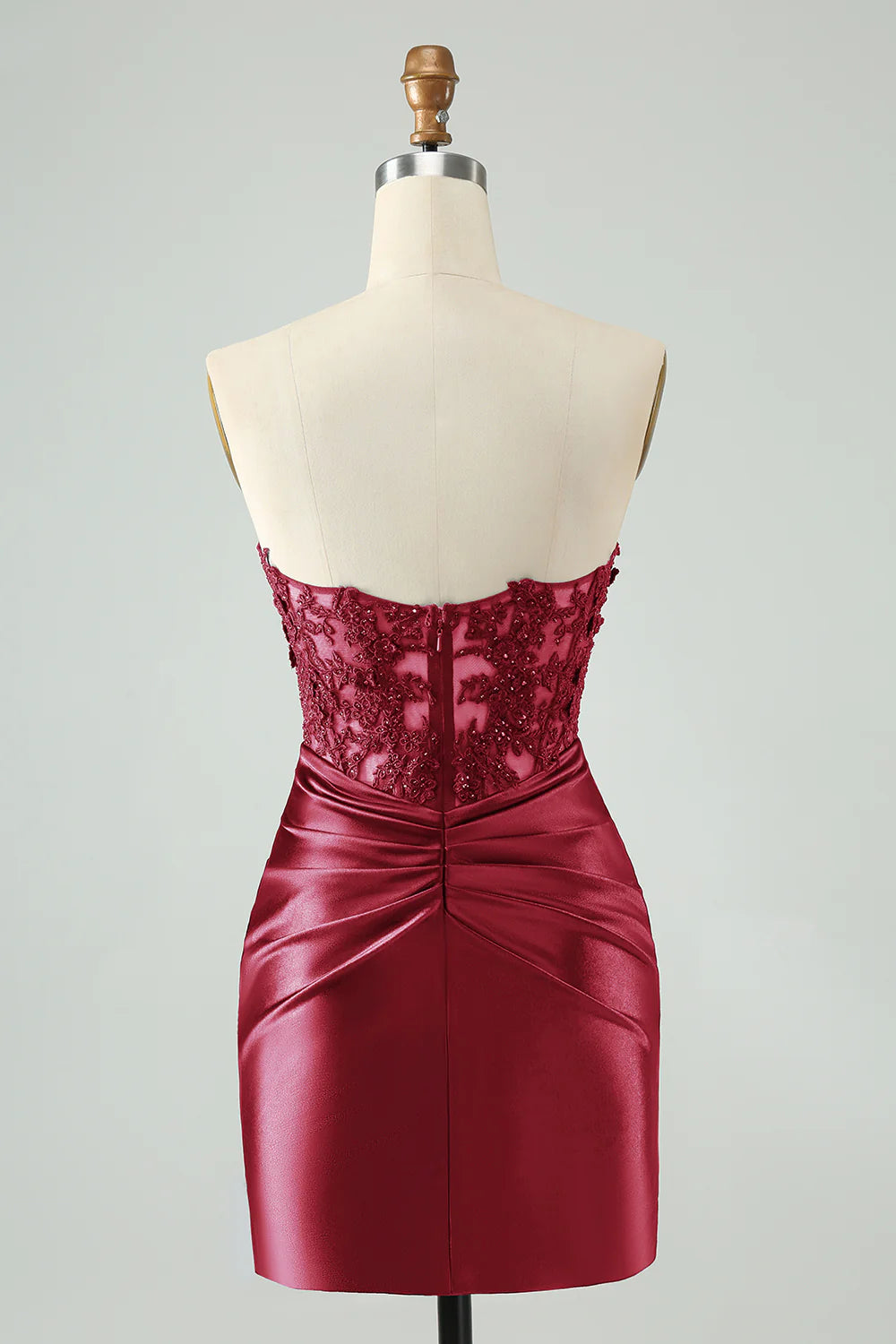 Back view of a burgundy short bodycon dress with hollow-out and beading.