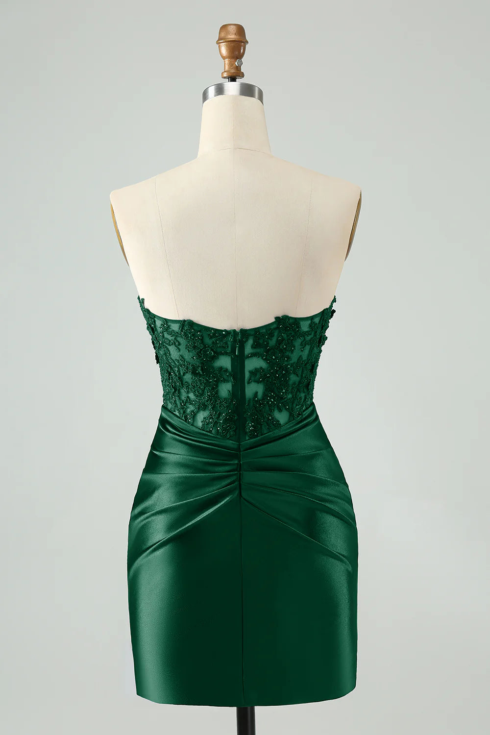 Side view of a dark green short bodycon dress with hollow-out and beading.