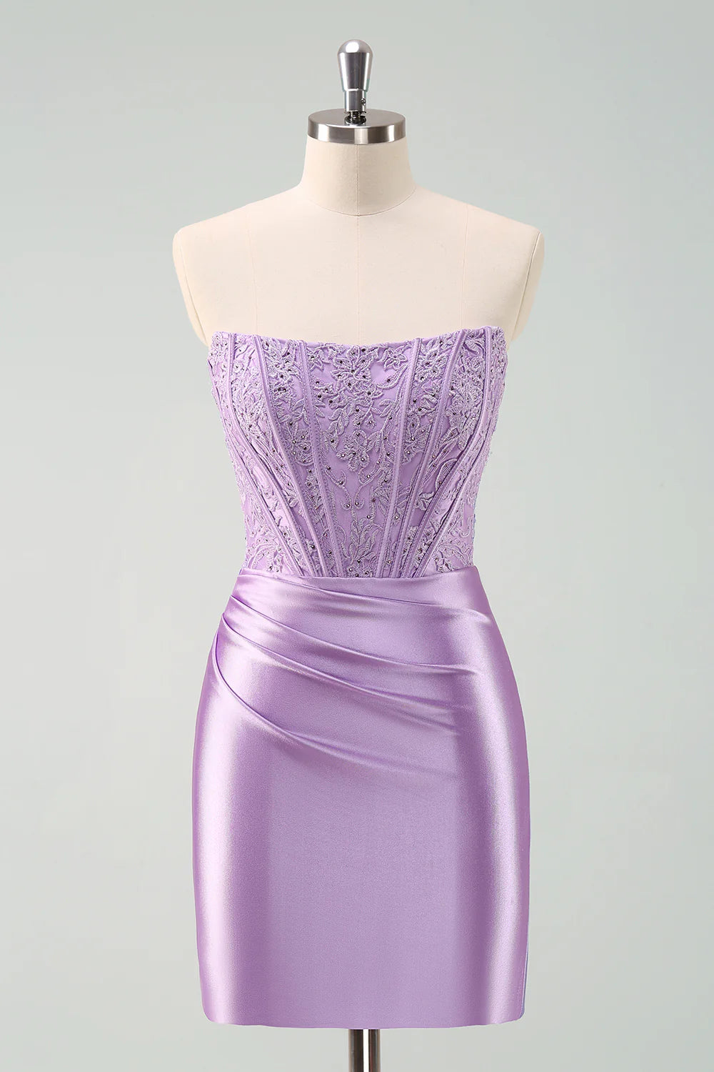 Purple bodycon short homecoming dress with pleated skirt and beaded corset.