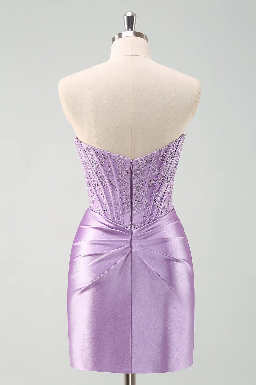 Side view of a model wearing the purple pleated bodycon homecoming dress.