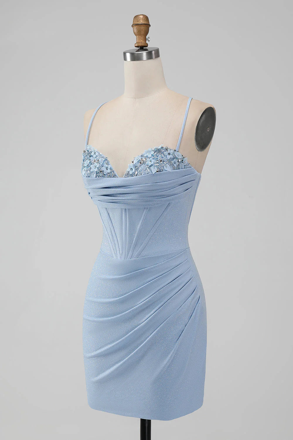 Model wearing a light blue bodycon short homecoming dress with spaghetti straps and corset bodice, back view.