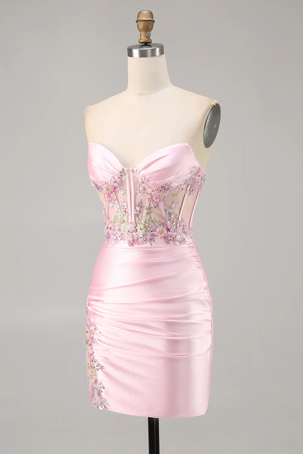 Close-up of appliques and ruched detailing on the Candy Pink strapless dress.