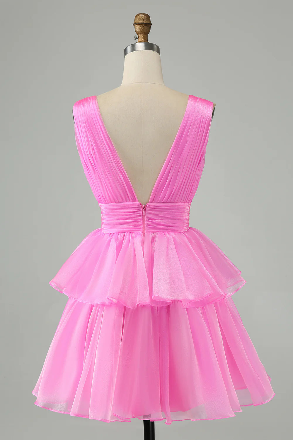 Detail of the V-neck and backless design on a hot pink homecoming dress.