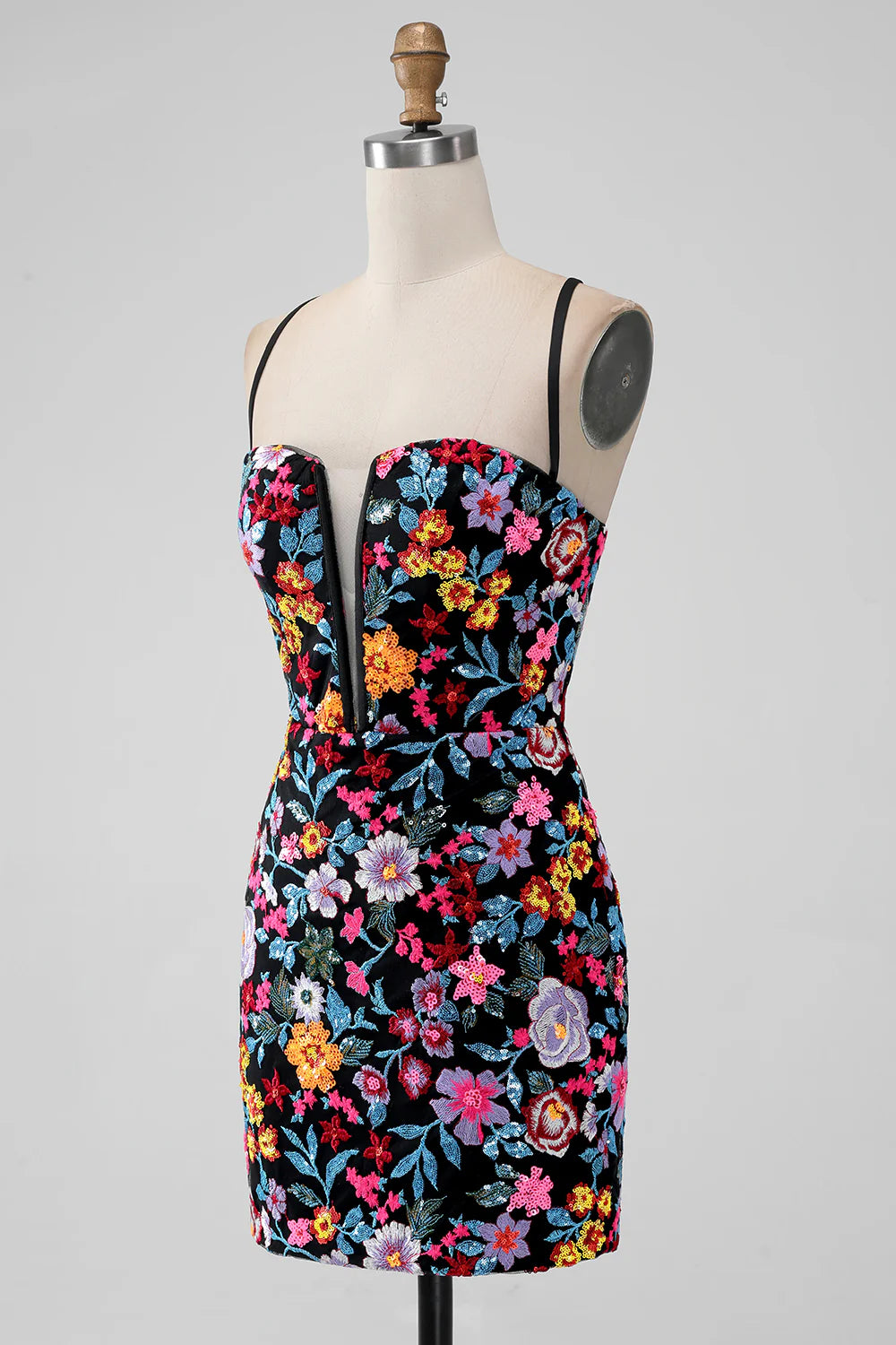 Model wearing a black short mermaid dress with intricate floral details.