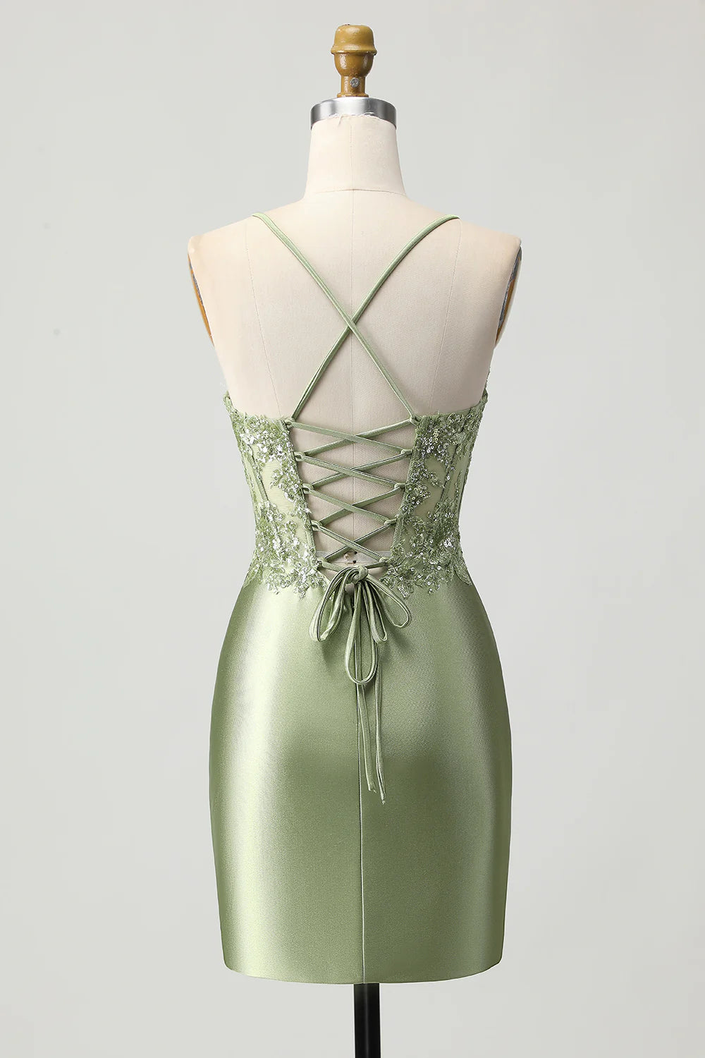 Back view of the sage green satin dress showing lace-up detail.