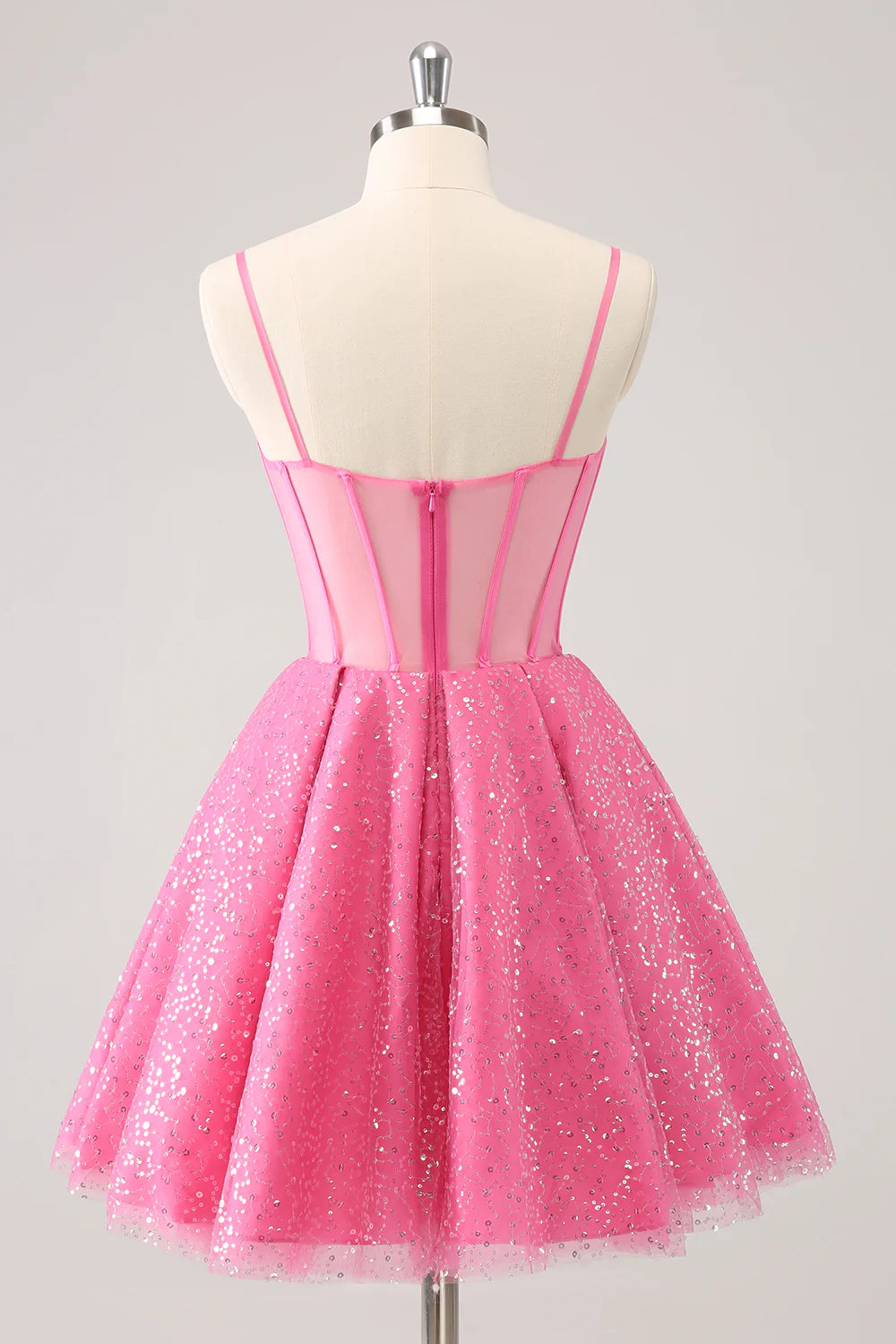 Close-up of the sparkly pink A-line homecoming dress showing sequin detail and corset back.