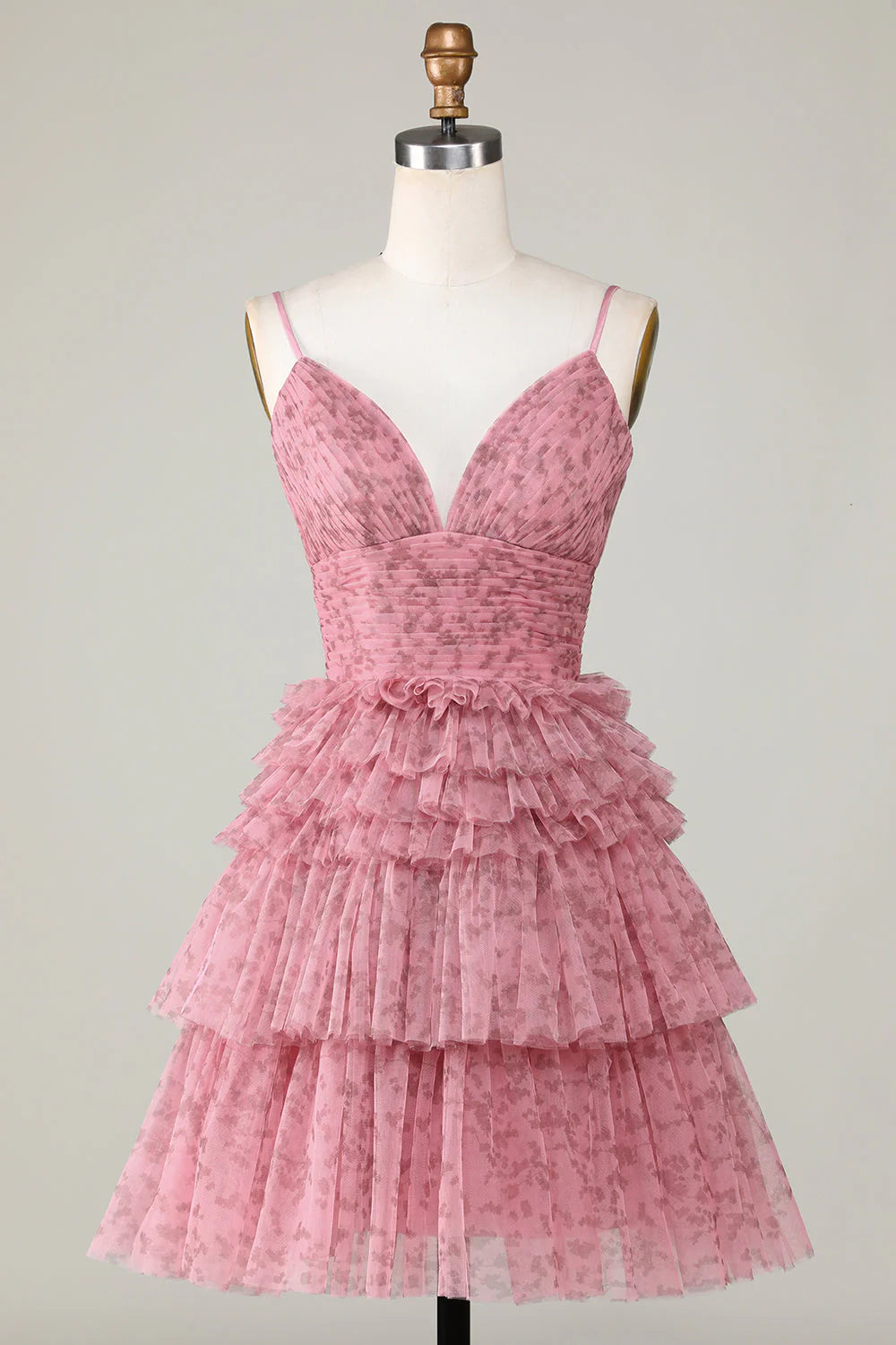 Blush A-line short homecoming dress with spaghetti straps and ruffles.