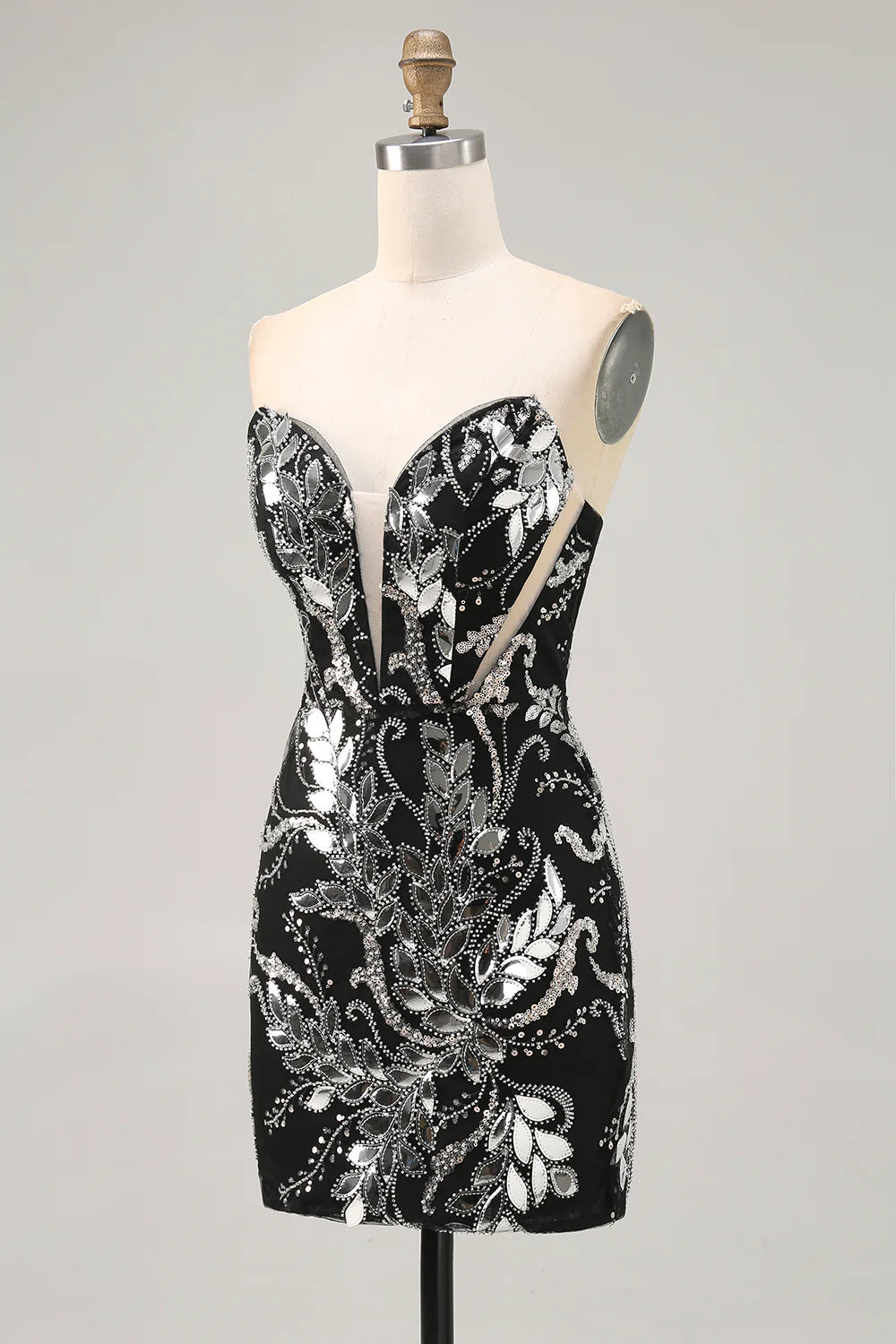 Close-up of intricate beading and sequins on a black strapless dress.