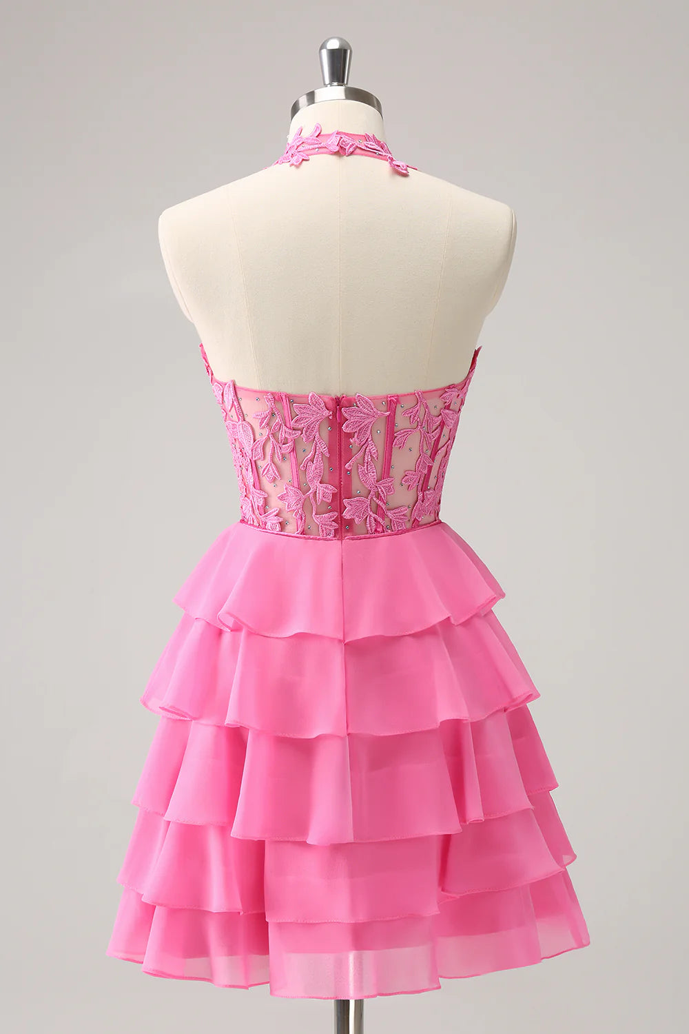 Close-up of the tiered ruffle skirt and delicate beading on the hot pink homecoming dress.