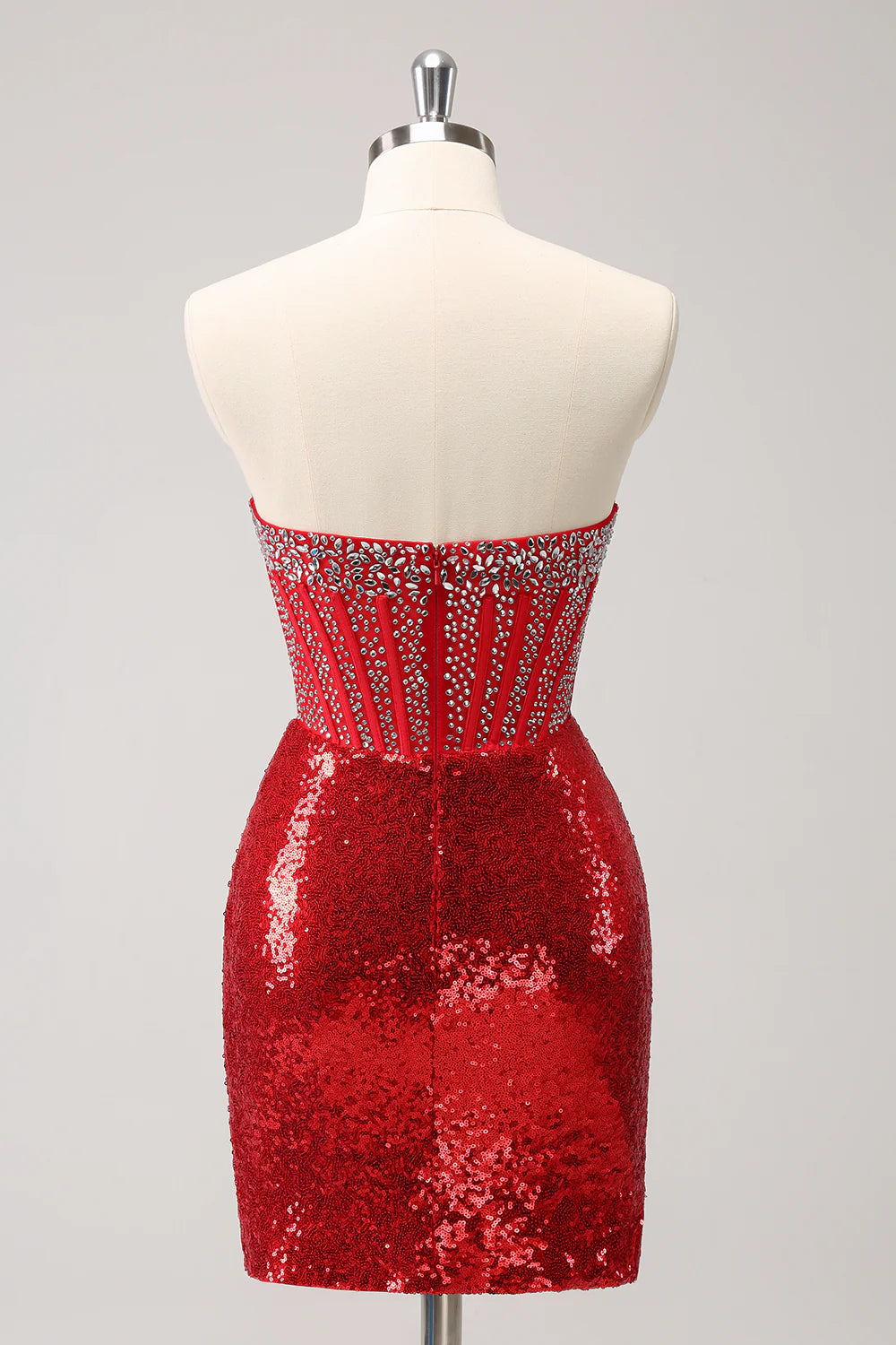 Back view of a red strapless sequin dress with corset detailing.
