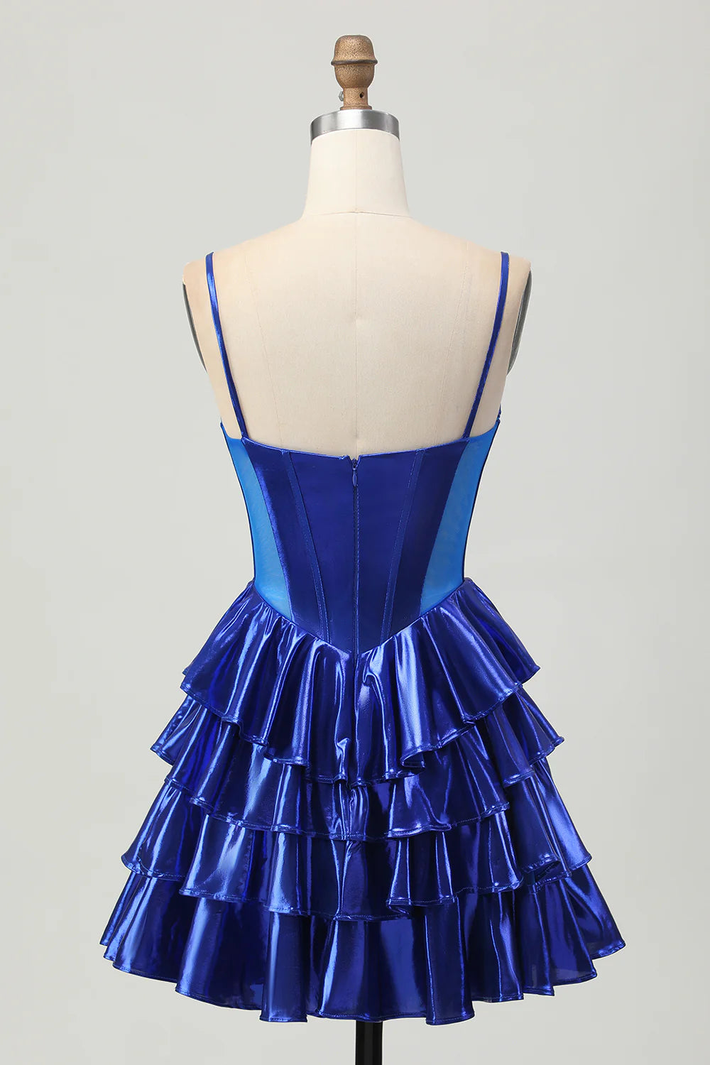 Side view of royal blue tiered homecoming dress, showcasing beaded corset and delicate bows.