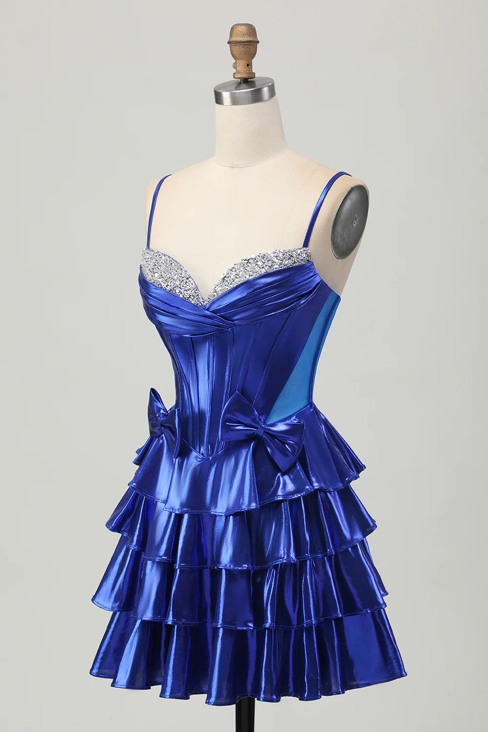 Back view of royal blue A-line dress, highlighting the tiered skirt and spaghetti straps.