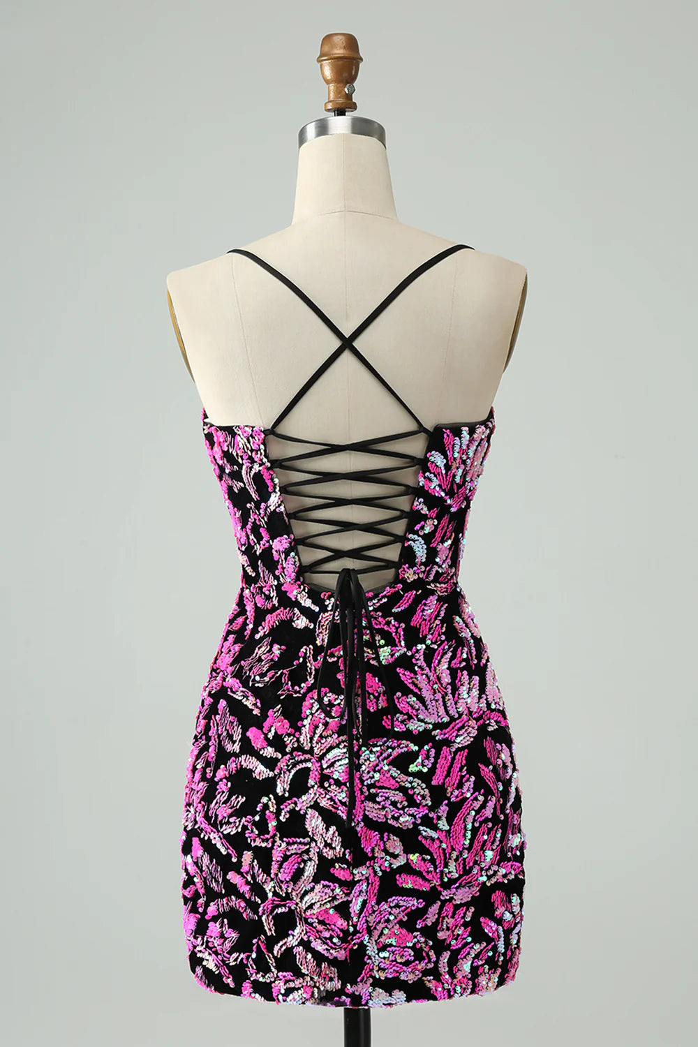Model wearing a fuchsia black sparkly sequin bodycon short homecoming dress.