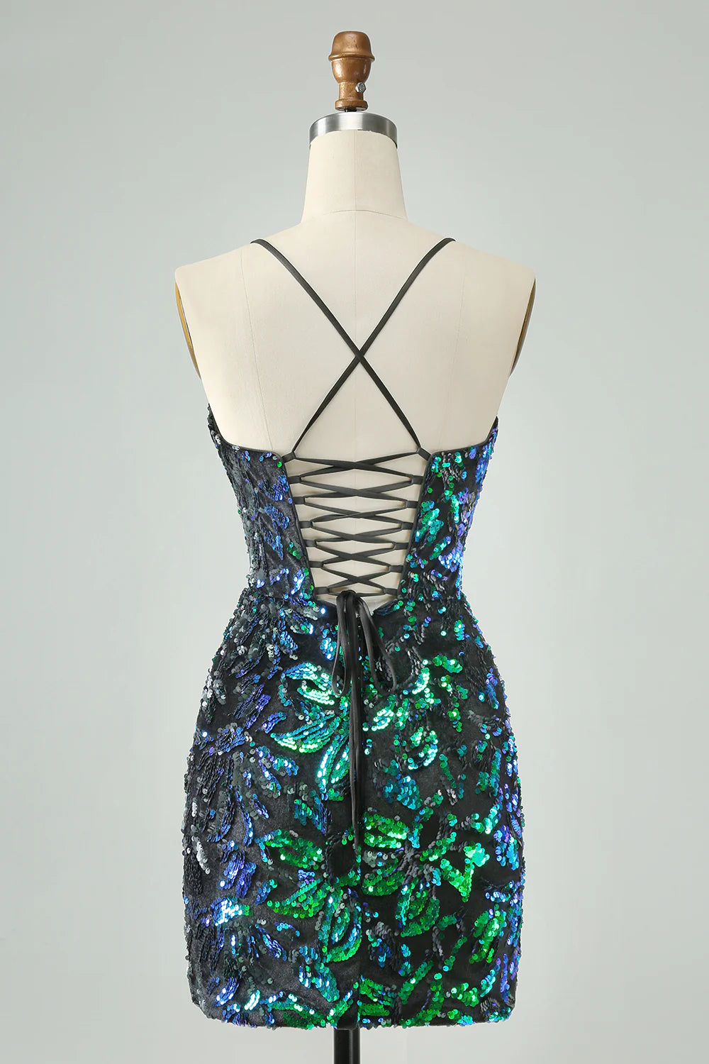 Model wearing a green black sparkly sequin bodycon short homecoming dress.