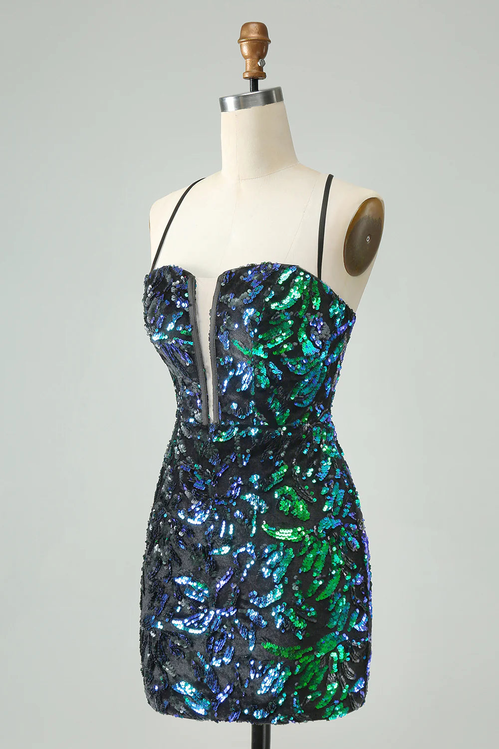 Model wearing a green black sparkly sequin bodycon short homecoming dress.