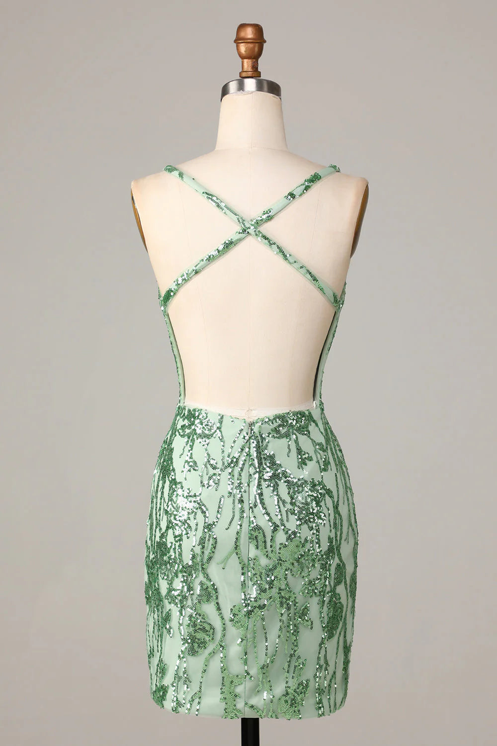 Close-up of the back of a sparkly green sequin short homecoming dress, showing the backless detail.