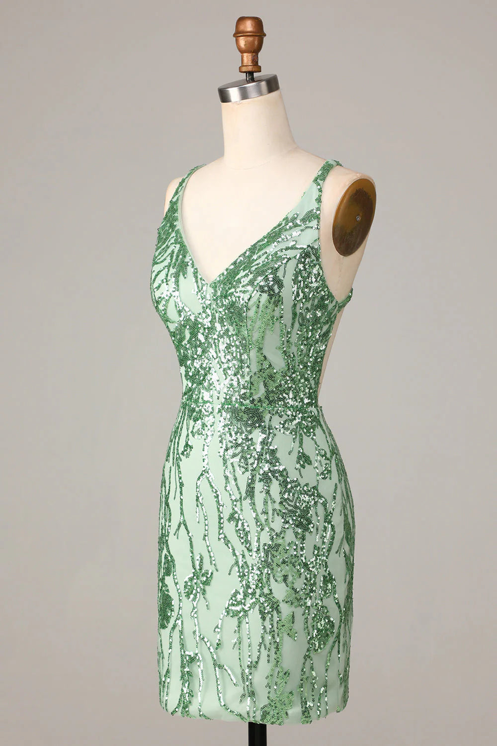 Side view of a model in a sparkly green sequin sheath V-neck short homecoming dress.