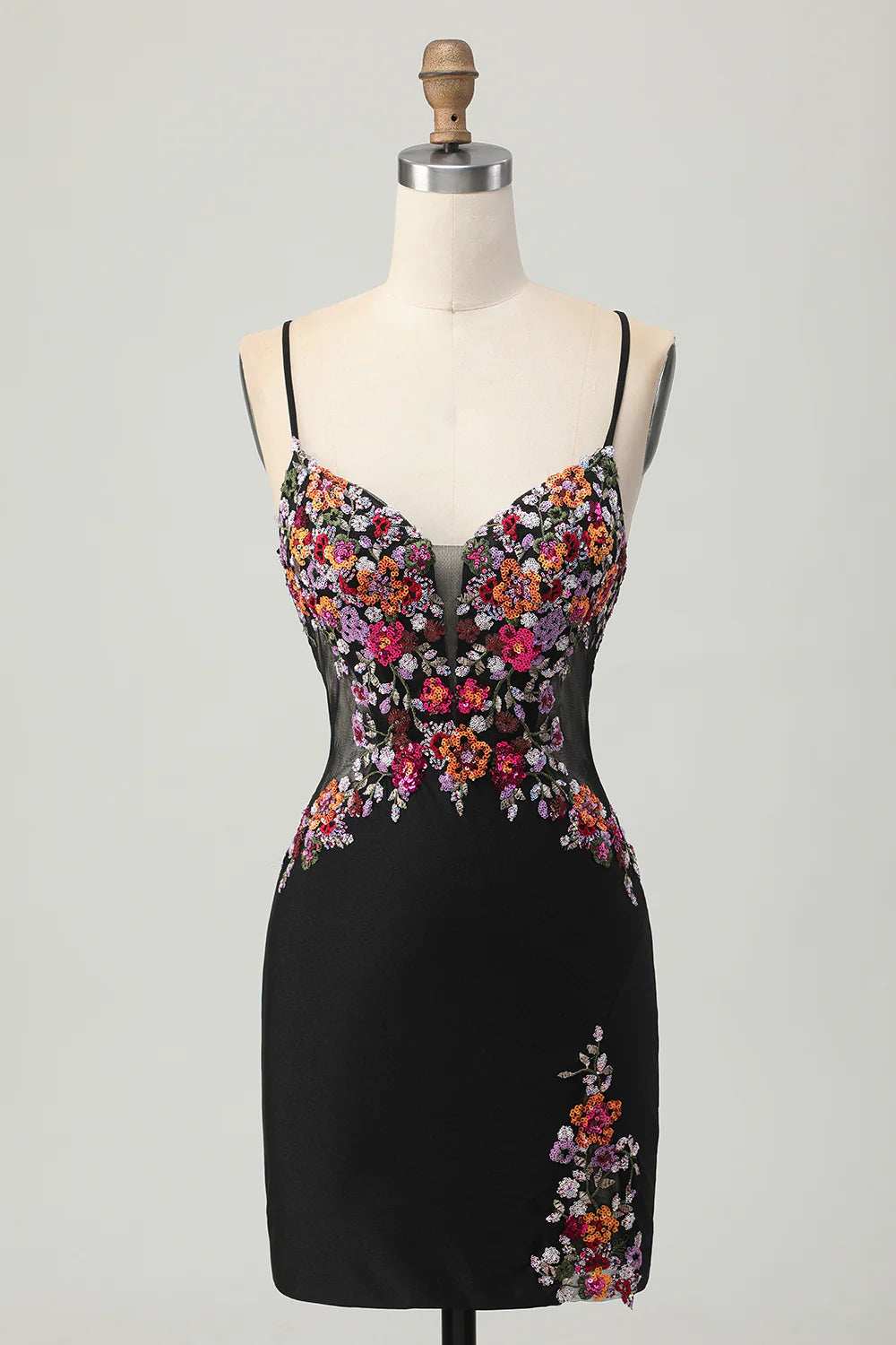 Model wearing a black floral sequin short homecoming dress with a tight silhouette.