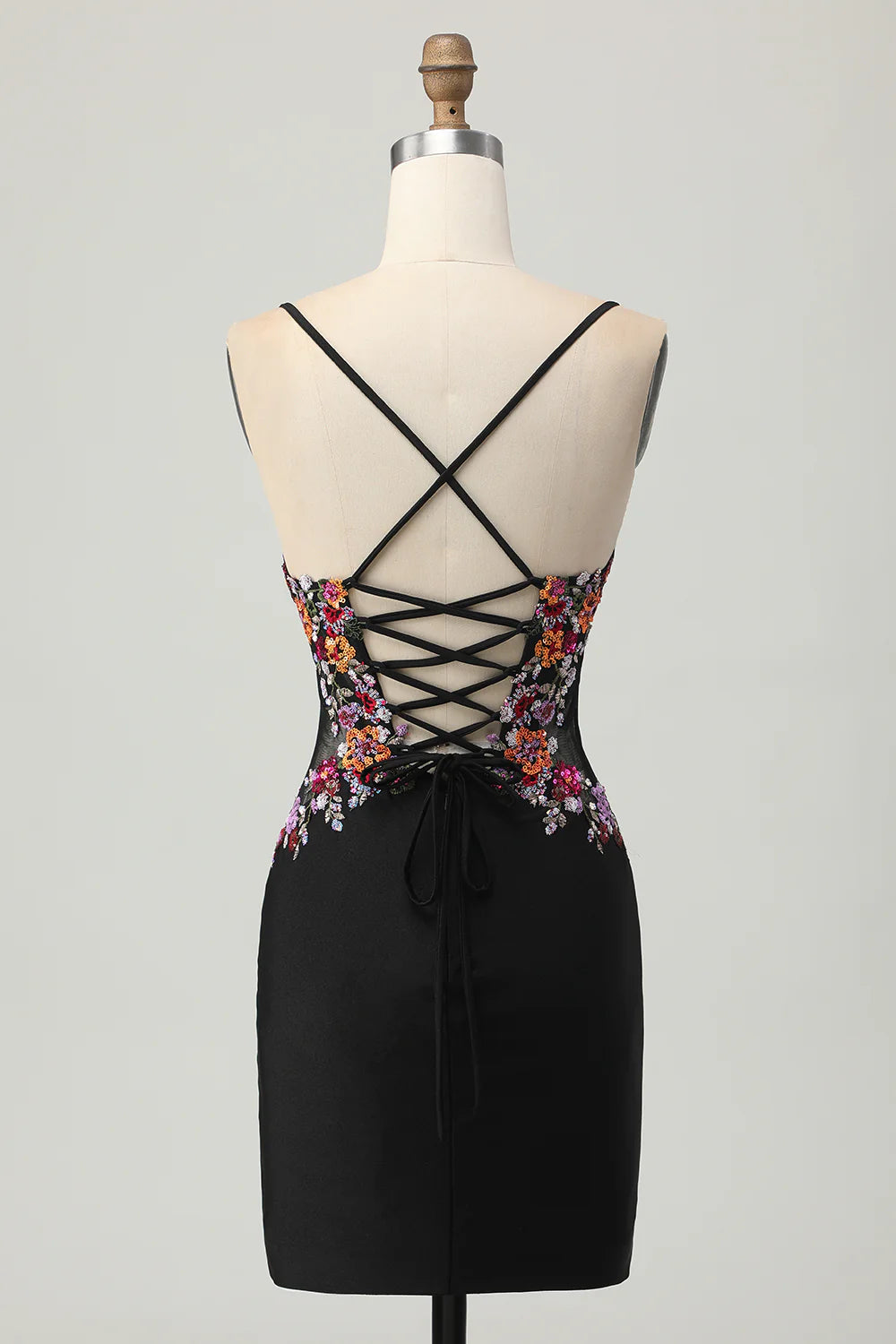 Back view of the black floral sequin dress, highlighting the adjustable lace-up detail.
