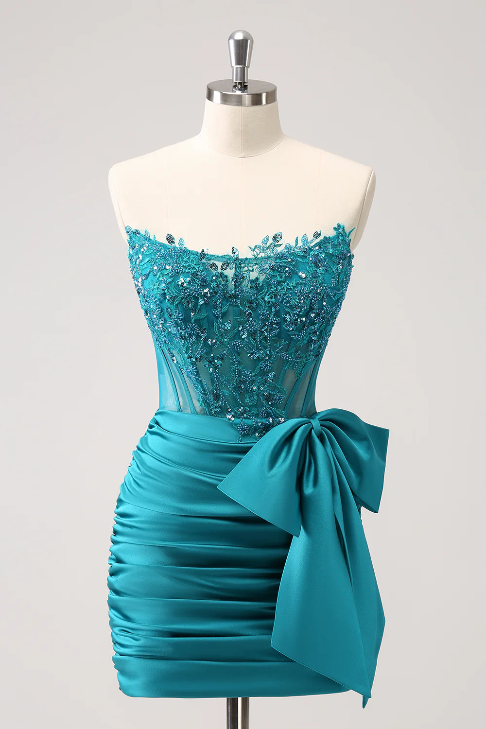Dazzling peacock strapless corset homecoming dress with beaded bodice and pleated short skirt.