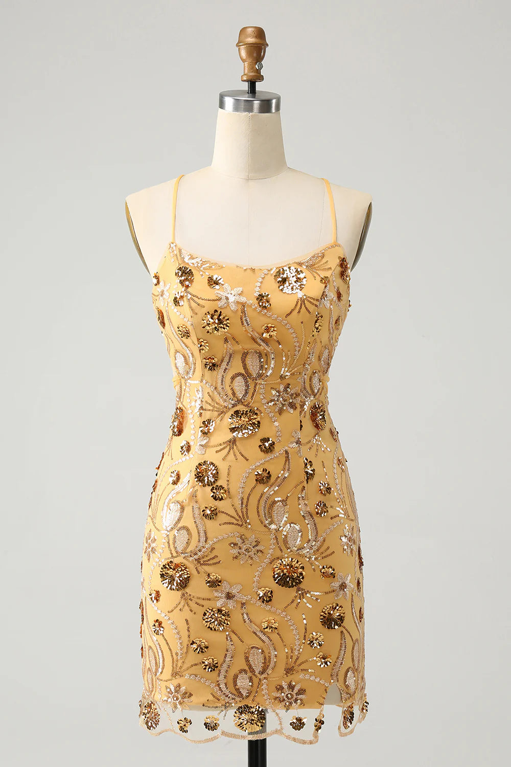 Yellow bodycon short homecoming dress with spaghetti straps and sequins.