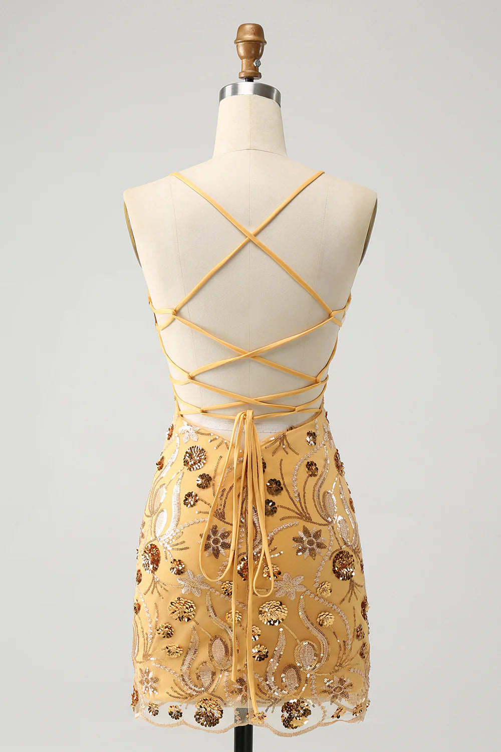 Back view of yellow sequin bodycon dress showing lace-up detail.